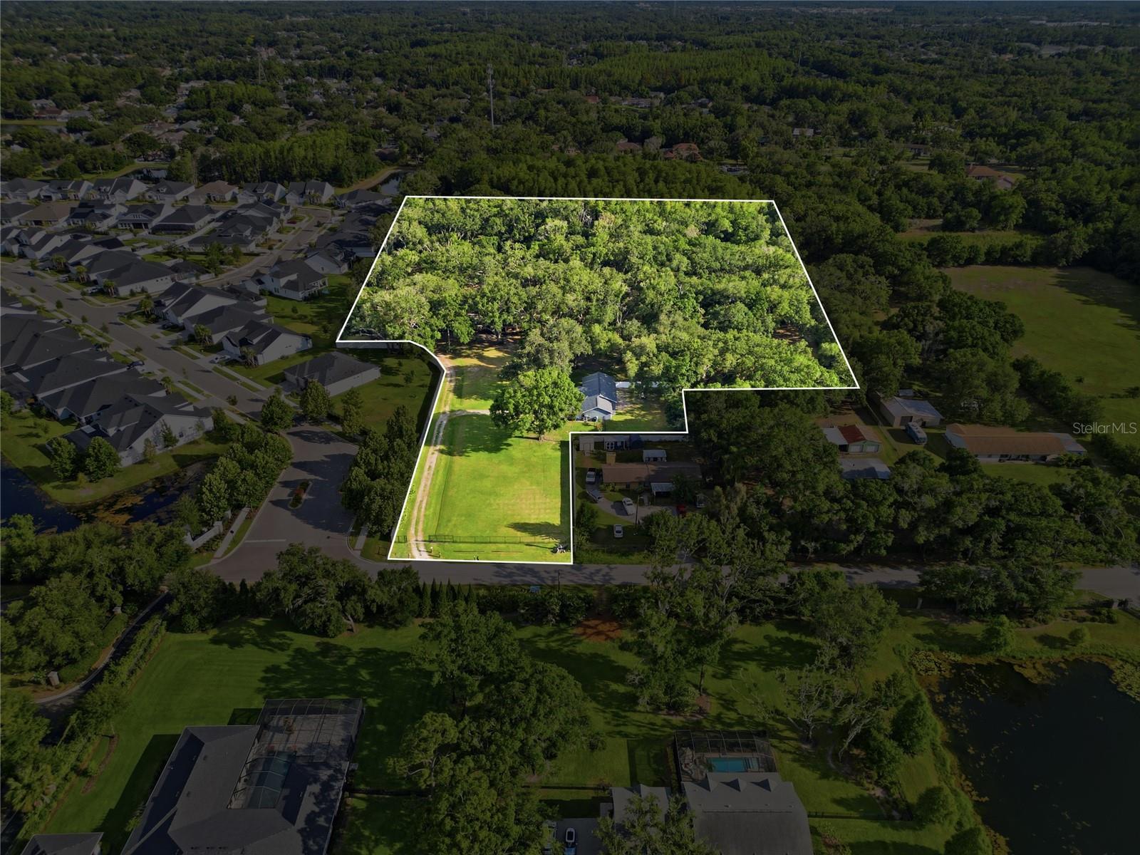 Aerial View with property boundary outlined (This is outlining the entire property including adjacent 2+ acres with sister house and shed)