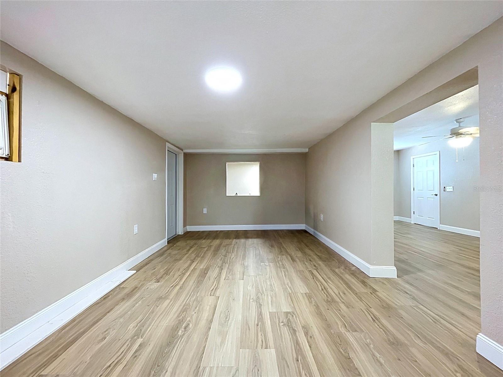 FLEX SPACE ON THE WEST SIDE OF THE HOME, DOOR ON LEFT EXITS TO THE WEST SIDE YARD.  LAUNDRY AREA AT THE BACK ON THE OTHER SIDE OF THE PASS THROUGH