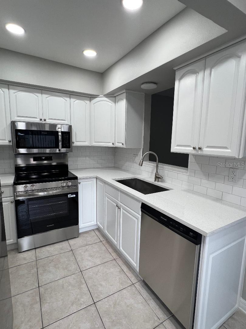 New country sink, counter tops and faucet.