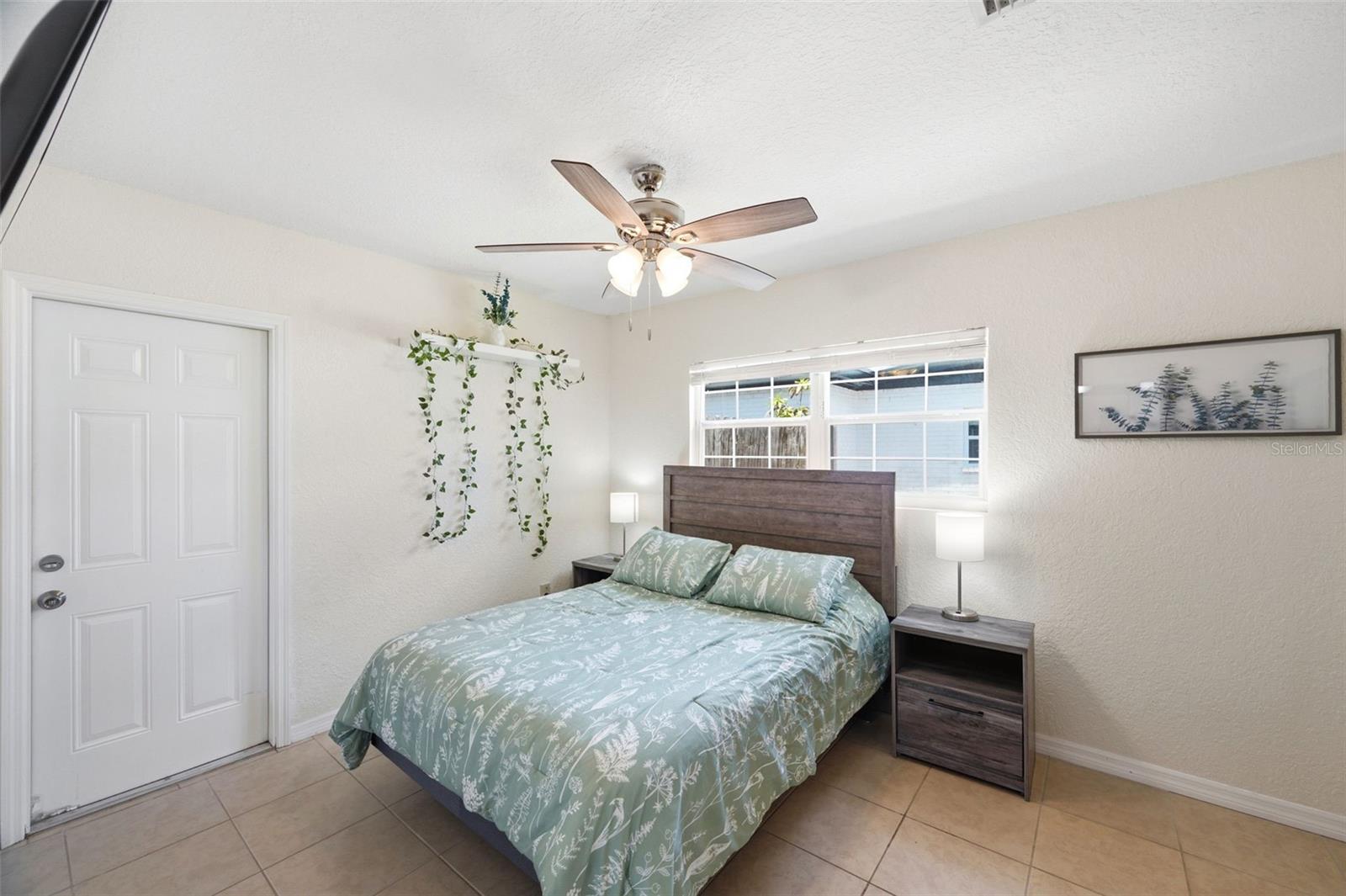 Primary Bedroom with walk-in closet and door to the Backyard.