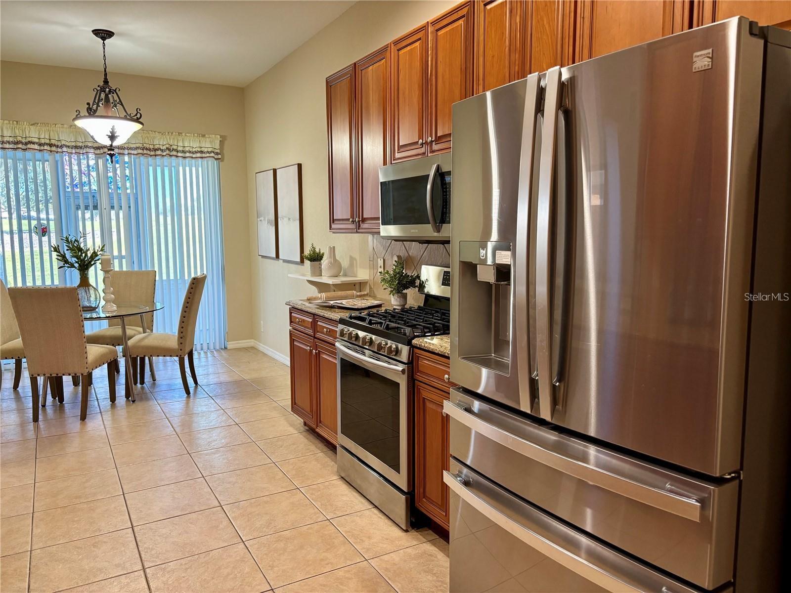 View of kitchen and dinette area out to the lanai and golf course.