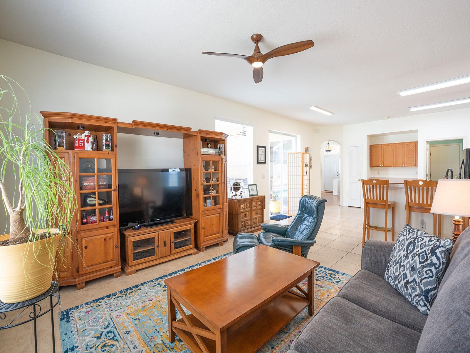 Family Room includes entertainment center (excluding center table and tv), lamp, table and artwork