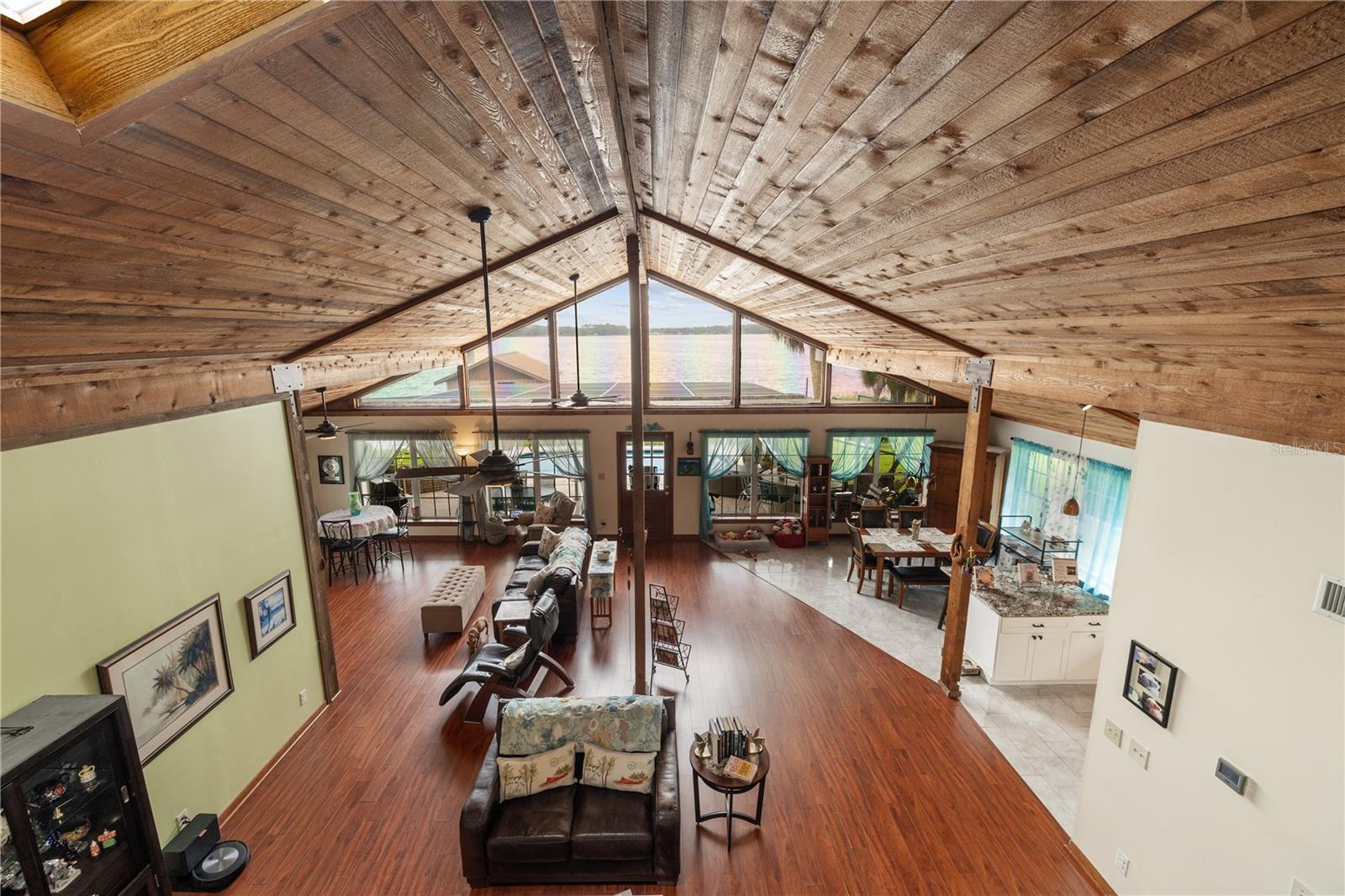 Cathedral Ceilings with Exposed Beams and Expansive Waterfront Views