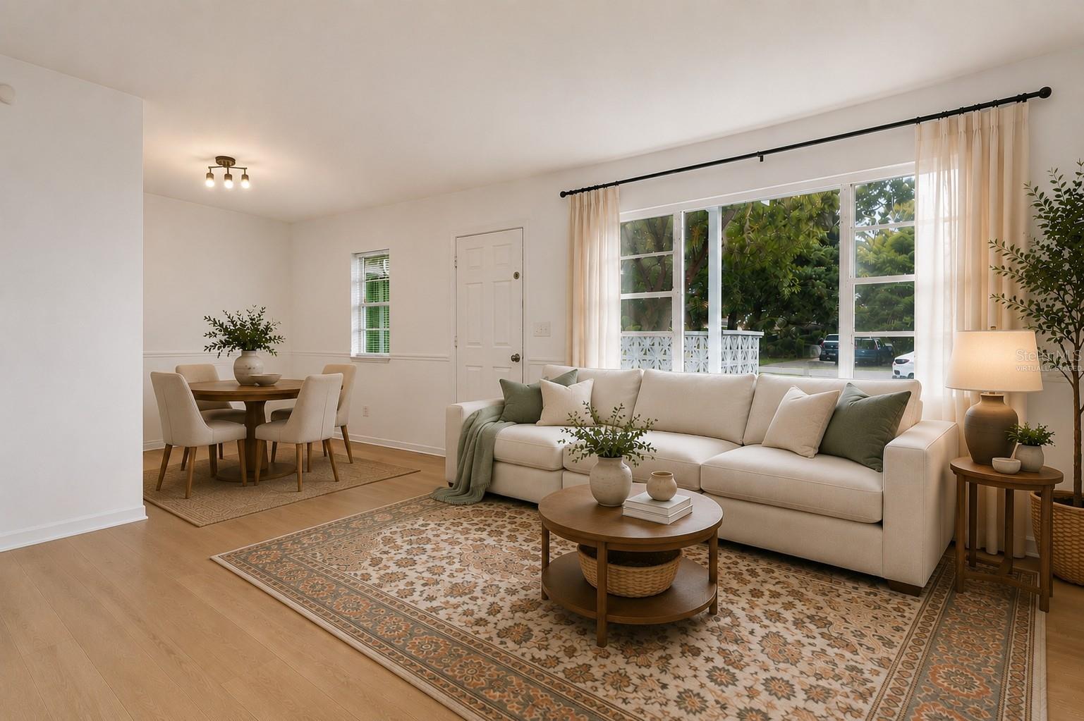 Virtually staged living room and dinette area.