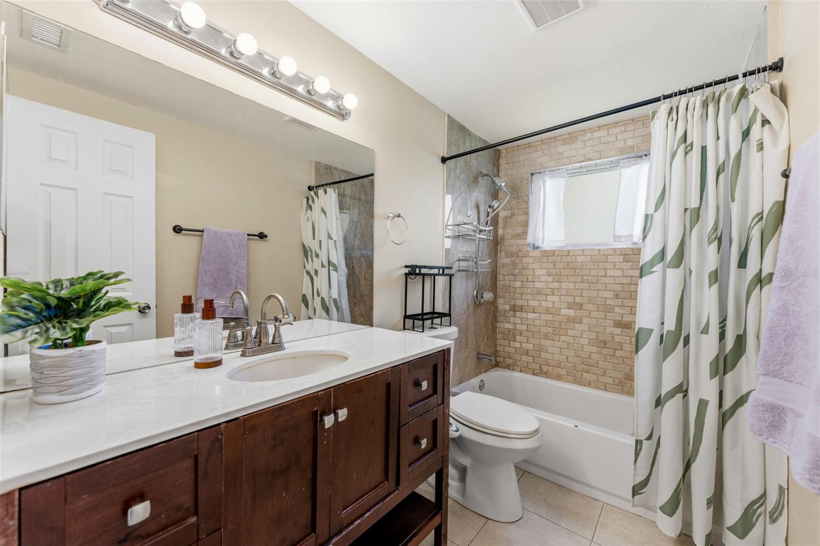 Primary bathroom with full tub and shower