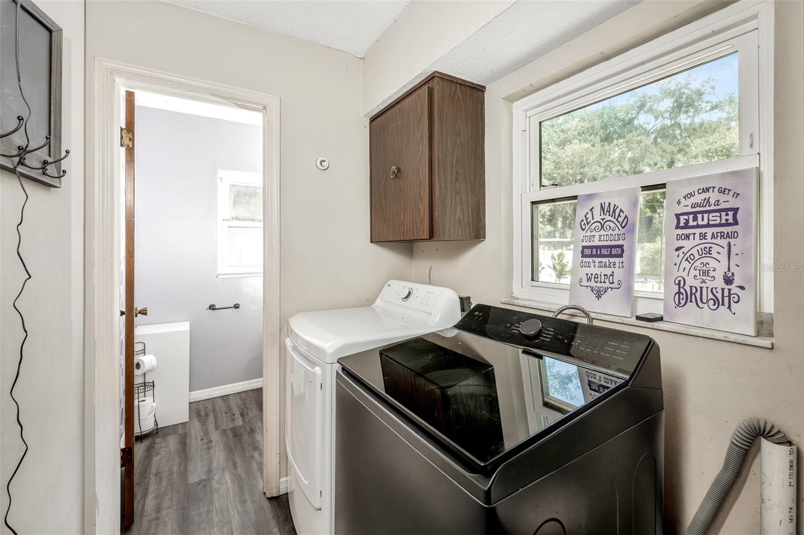 Laundry room with 1/2 bath leading from family room with