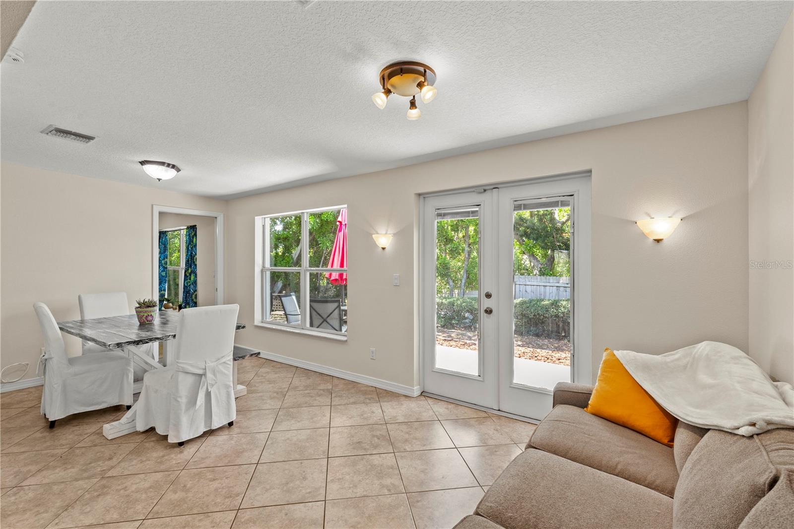 Versatile Florida room filled with natural light, offering the perfect space for a dining area, sitting room, home office, or additional living space. Large windows create a bright and airy atmosphere while providing beautiful views of the outdoors