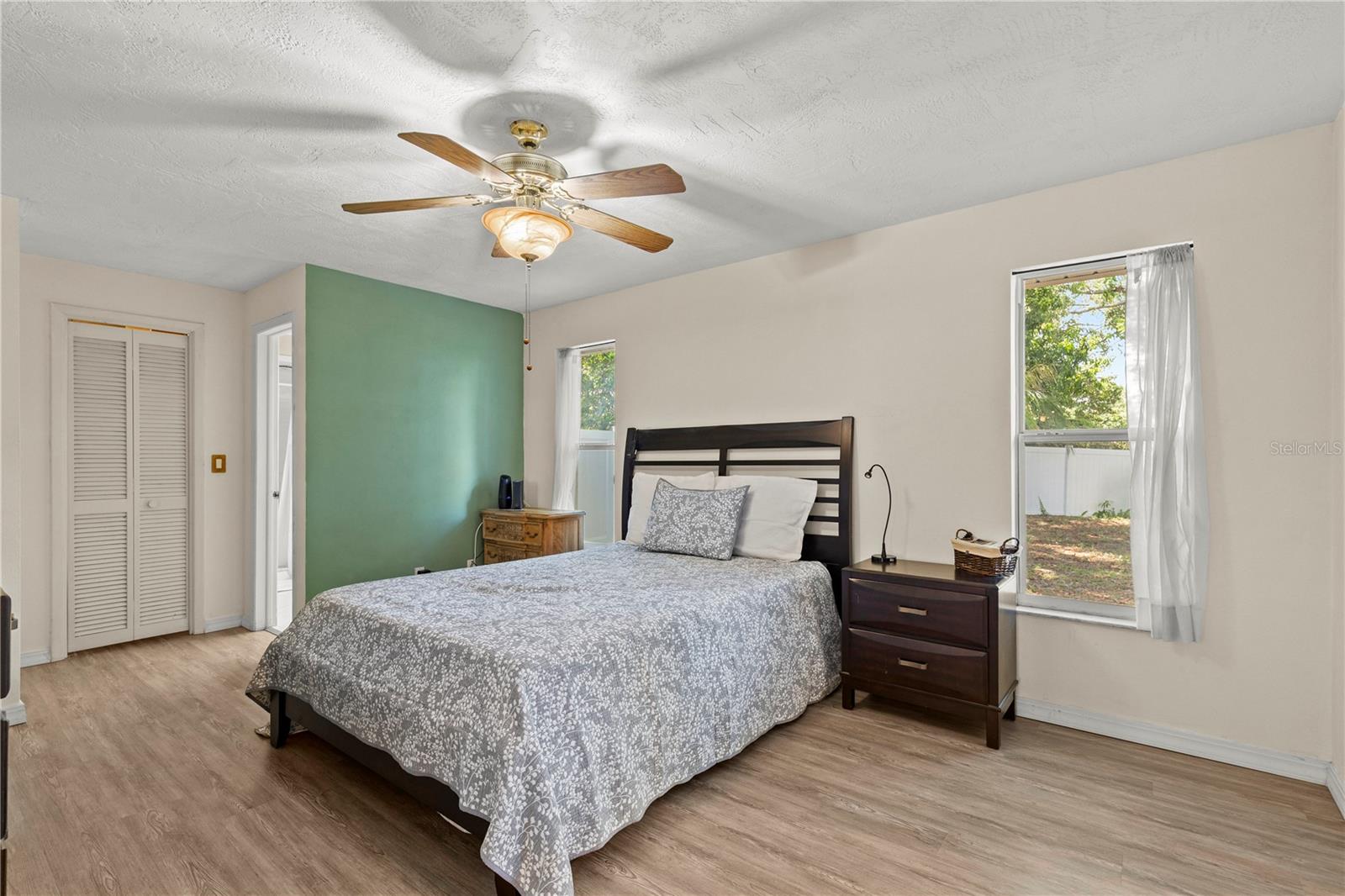 Spacious primary bedroom retreat featuring a bright and airy layout, offering a comfortable and private space to unwind. The room provides ample natural light and a peaceful atmosphere, creating the perfect owner’s suite for rest and relaxation