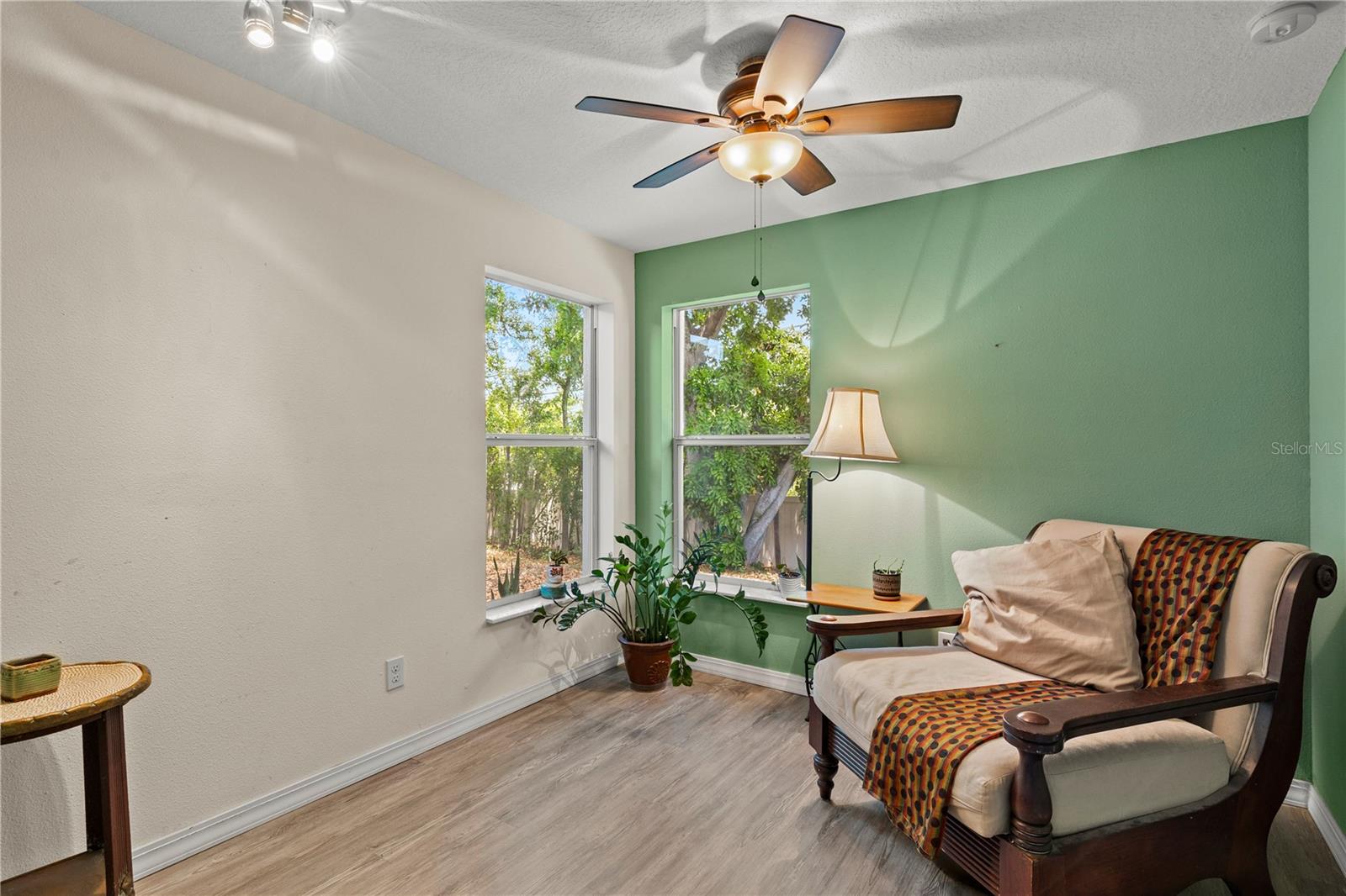 Spacious primary bedroom retreat featuring a bright and airy layout with a comfortable sitting area, creating the perfect space for relaxation and privacy. The room offers abundant natural light and a peaceful atmosphere, ideal for an owner’s suite designed for comfort and everyday living.