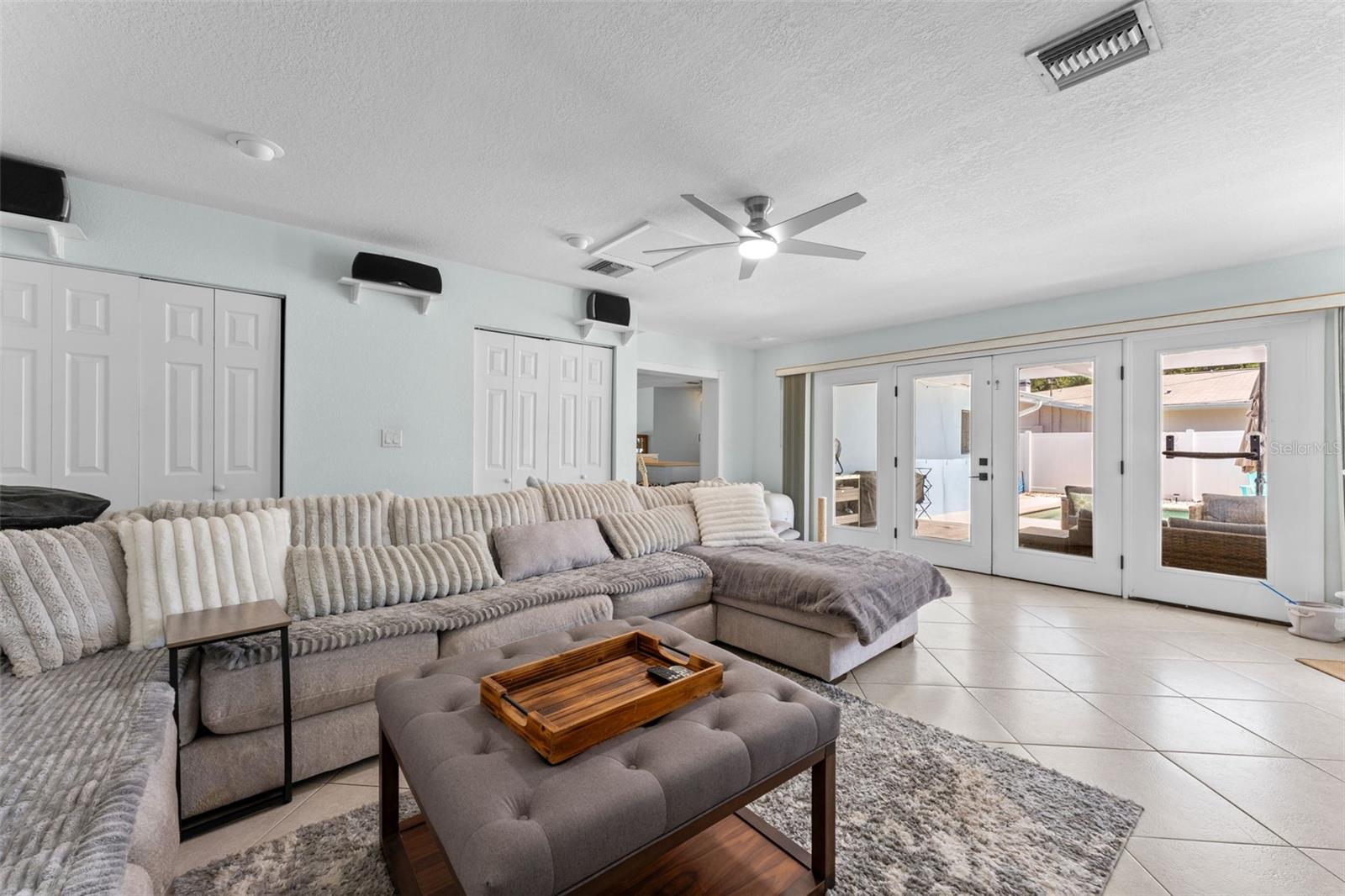 Extra large family room with french doors to pool