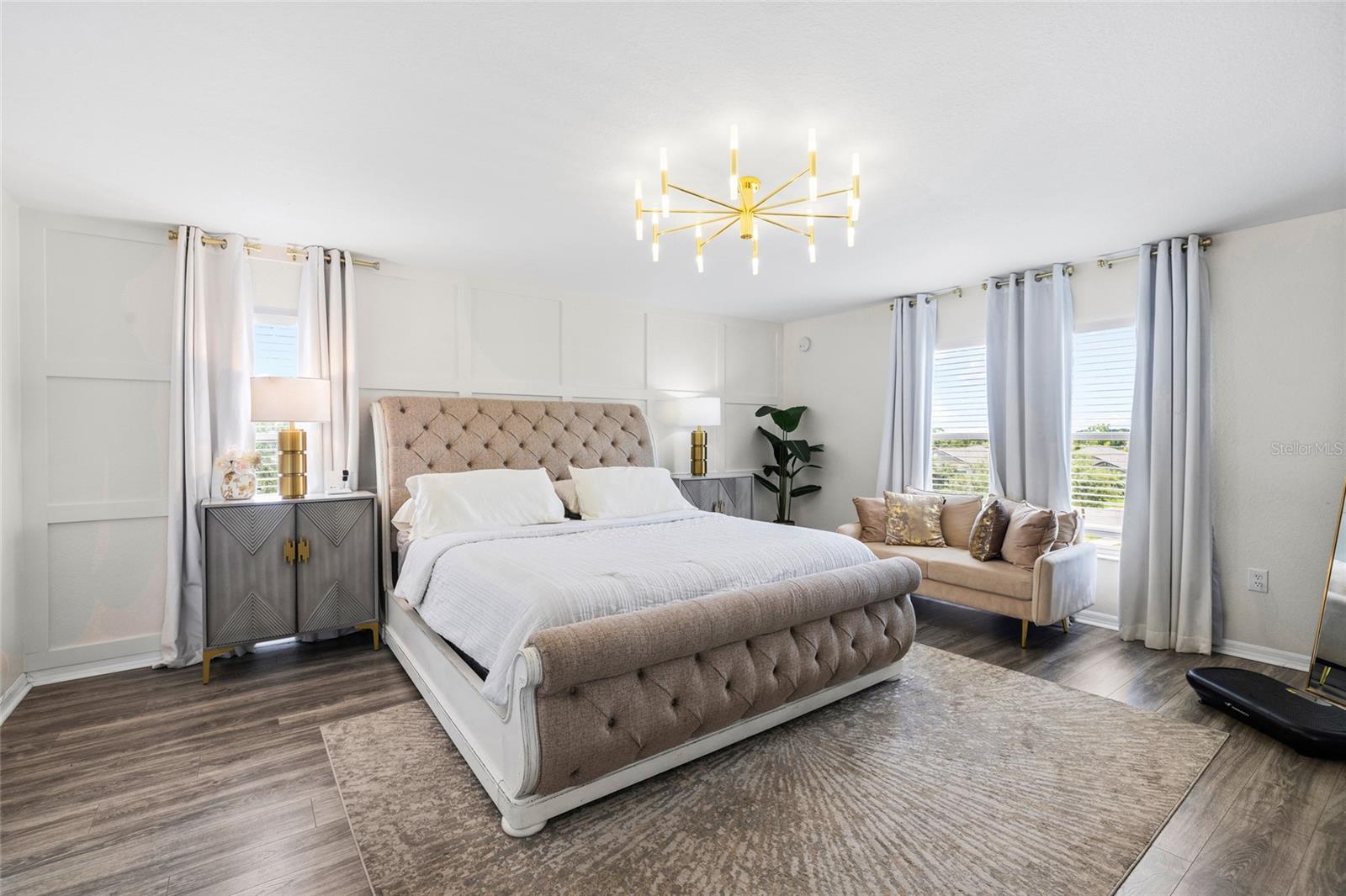 Oversized primary suite offering generous space, luxury flooring, and room for a private sitting area.