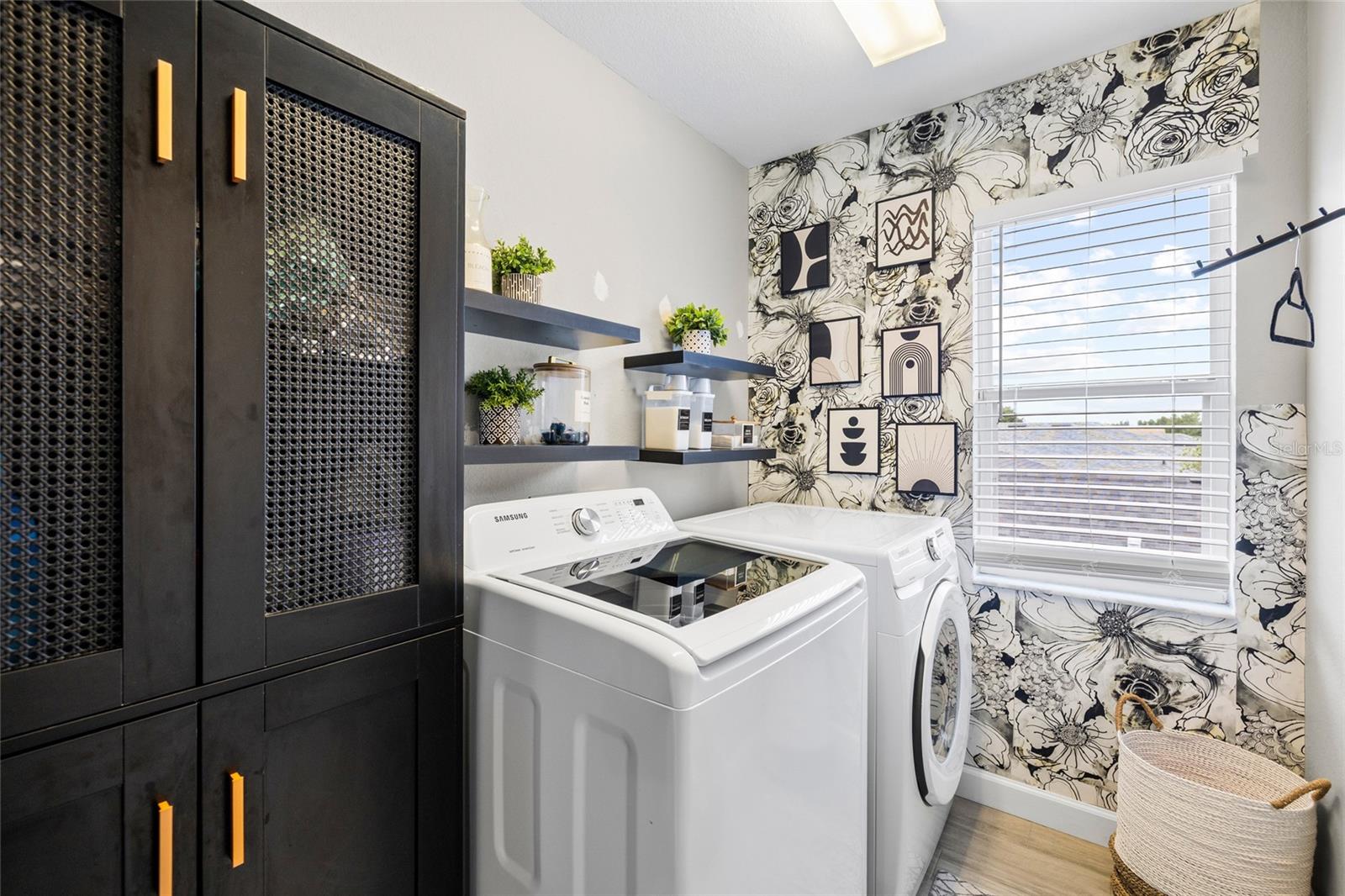 Dedicated laundry room with additional storage and functional workspace.