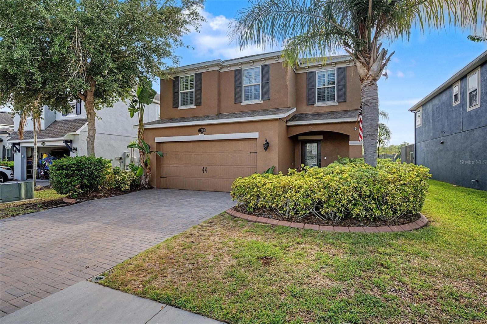 Covered front entry and pavered driveway make a great first impression!