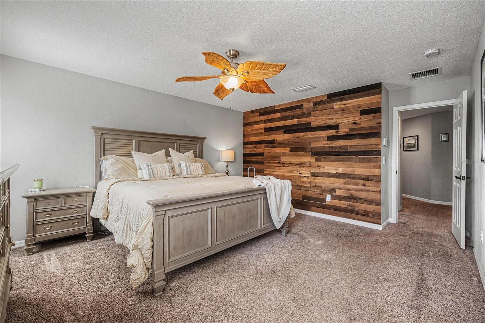 Primary bedroom with custom accent wall