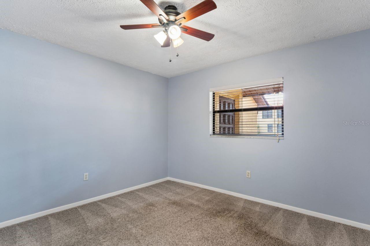 Guest bedroom, ceiling fan, walk in closet, attic access is in the closet it has pull down stairs.