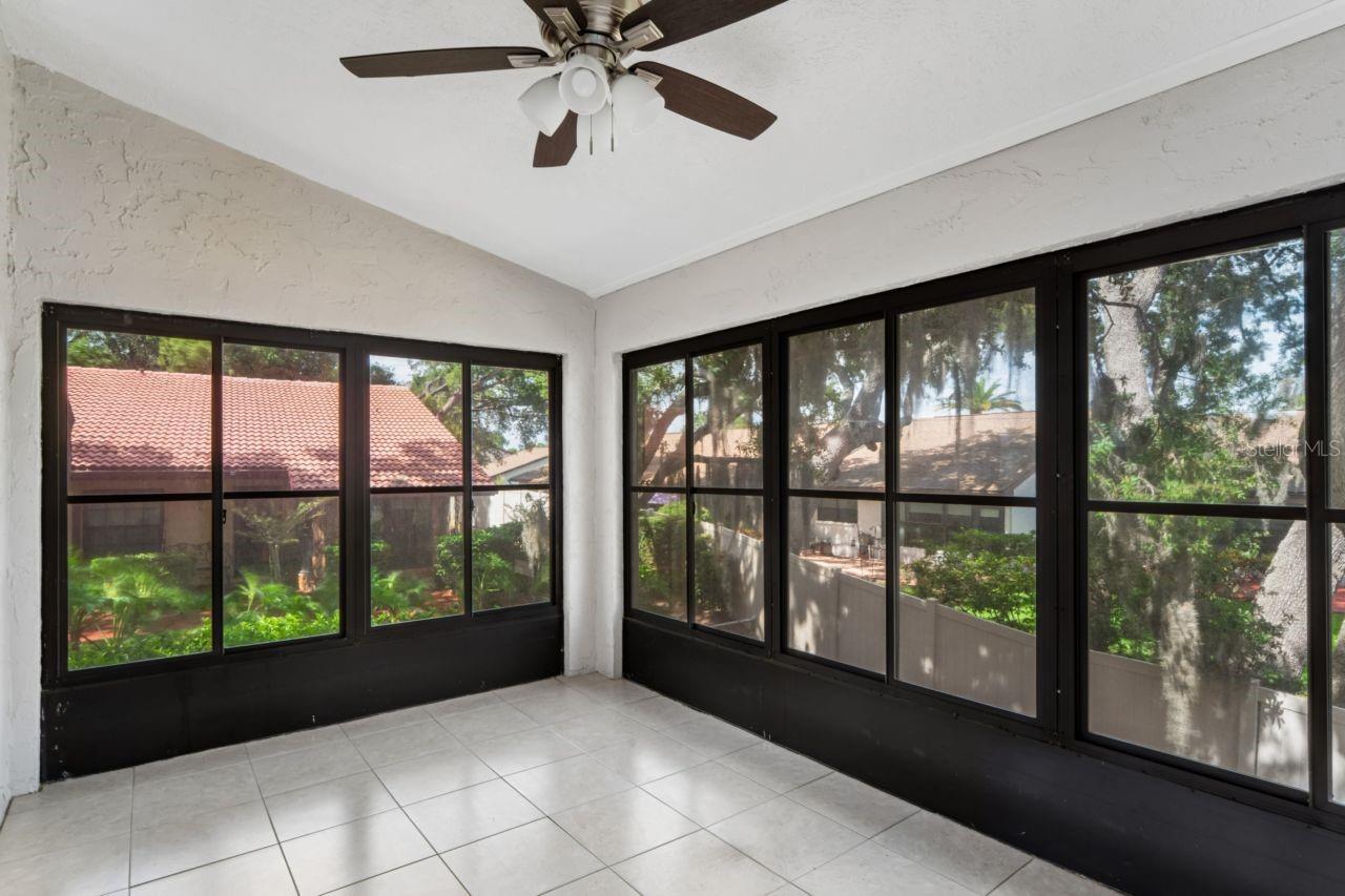 Beautiful lanai has ceiling fan, windows that open.