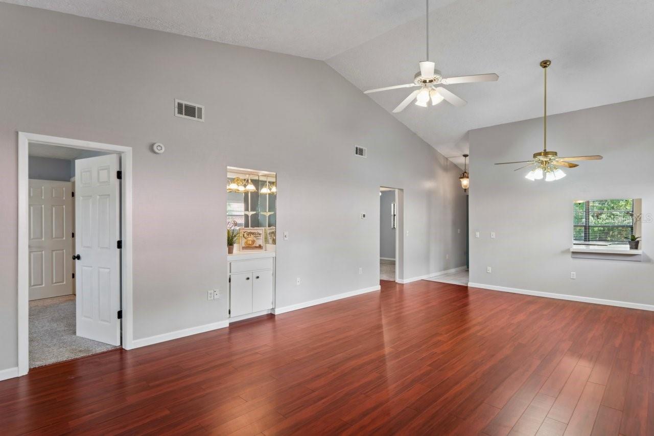 Entrance to the primary bedroom. Dining area, ceiling fan, cathedral ceilings and breakfast bar from the kitchen.