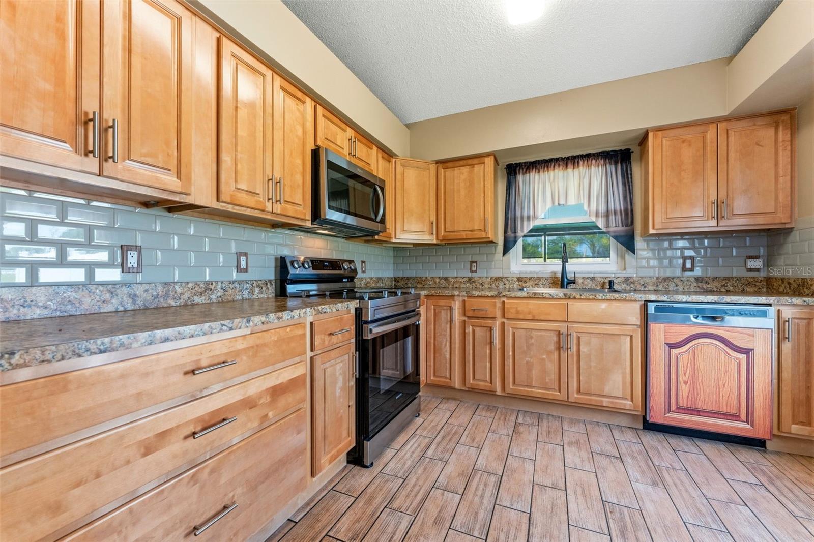 Kitchen with Stainless Steel Appliances. Dishwasher has been replaced since photos, brand new installed June 2026