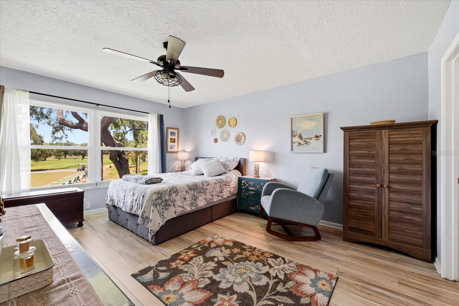 Primary bedroom with view of golf course.