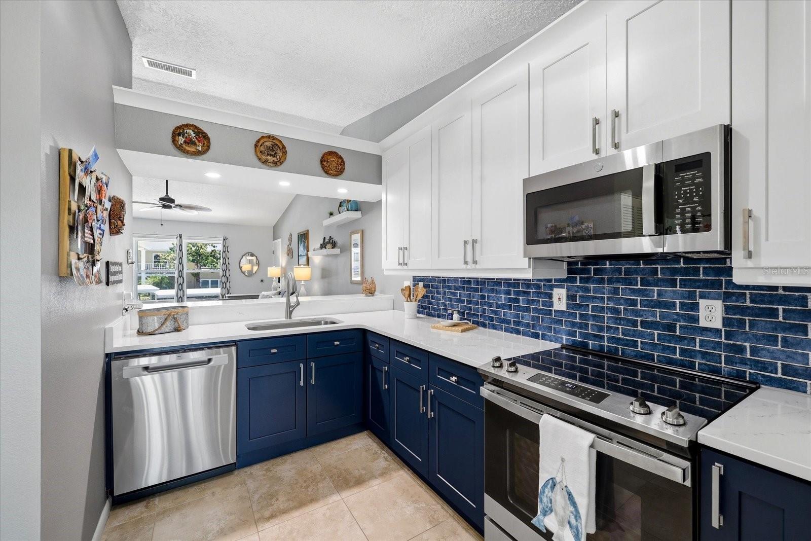 Updated kitchen -Stainless steel appliances, shaker cabinets, quartz countertops.
