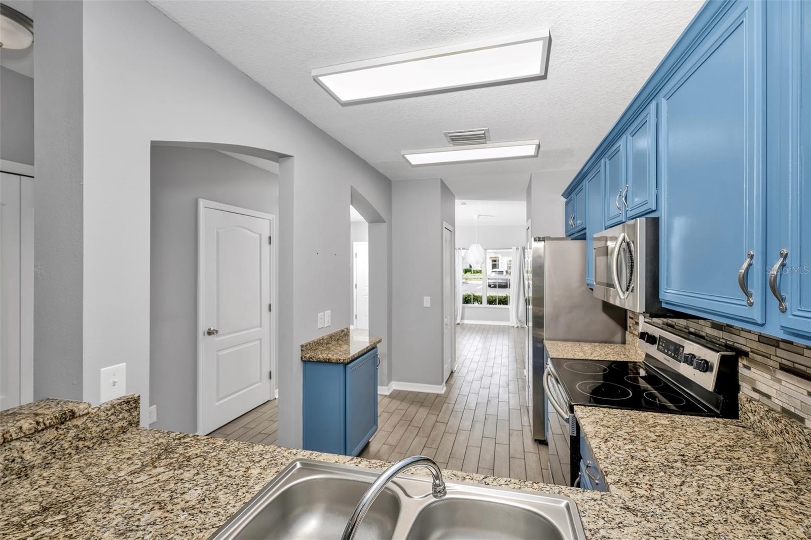 Upgraded kitchen with granite counters and stainless steel appliances