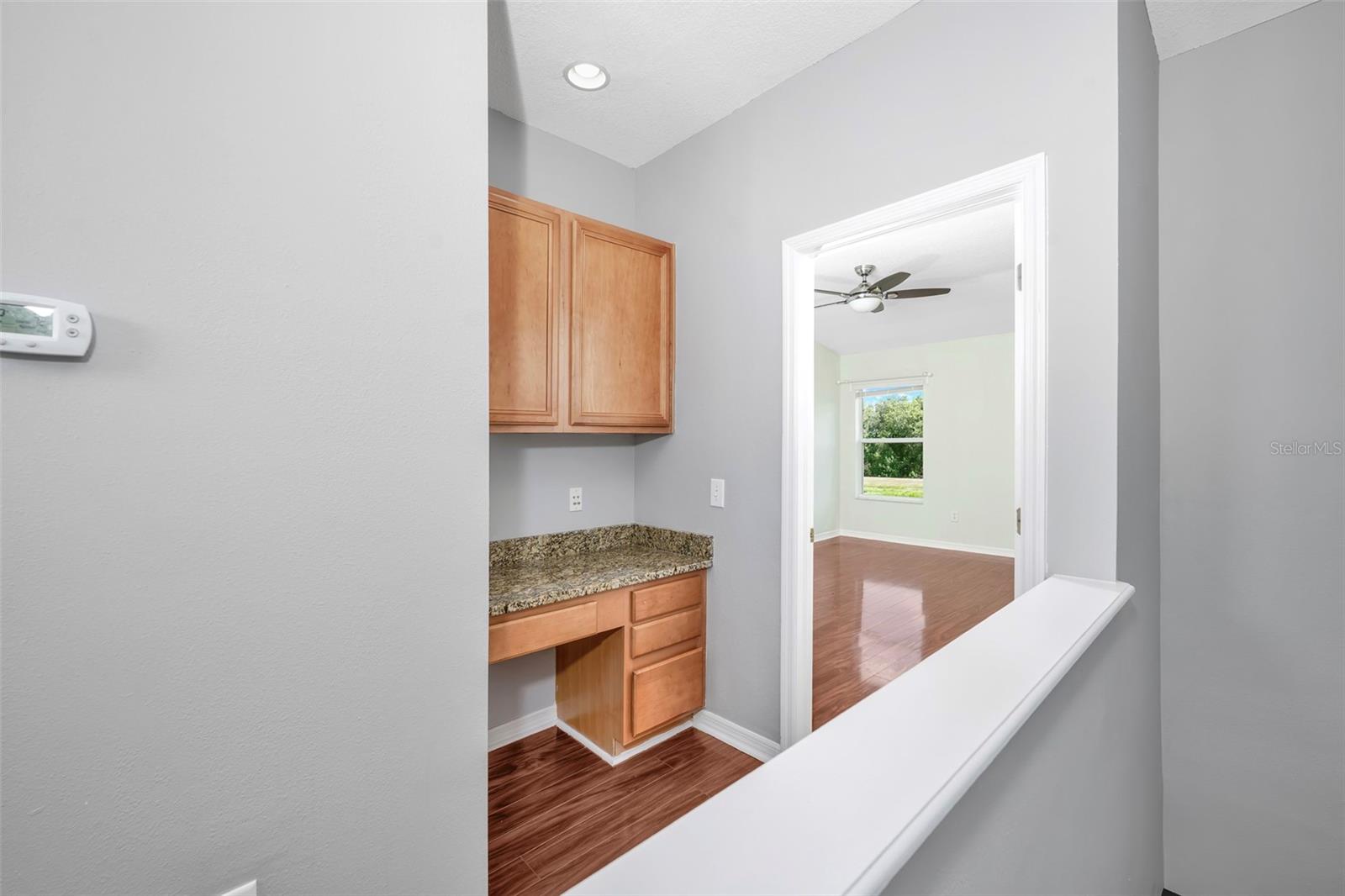 Desk feature leading into primary bedroom