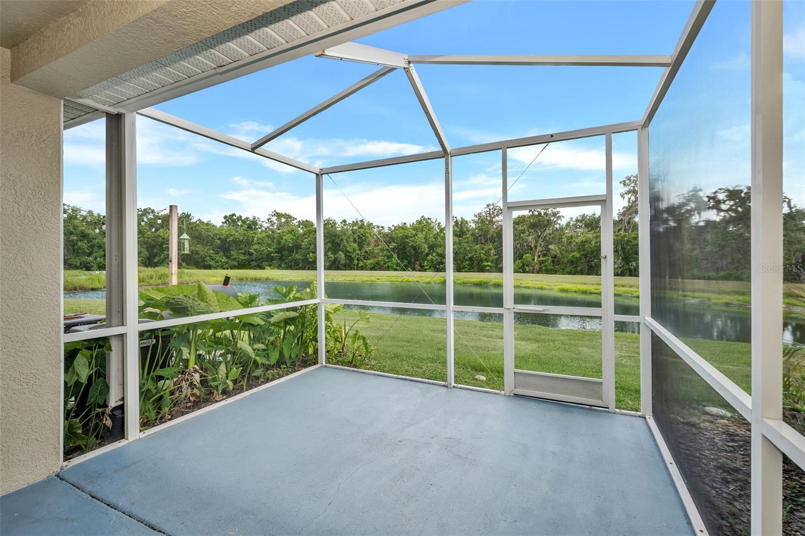 Private screened-in lanai with water and conservation views