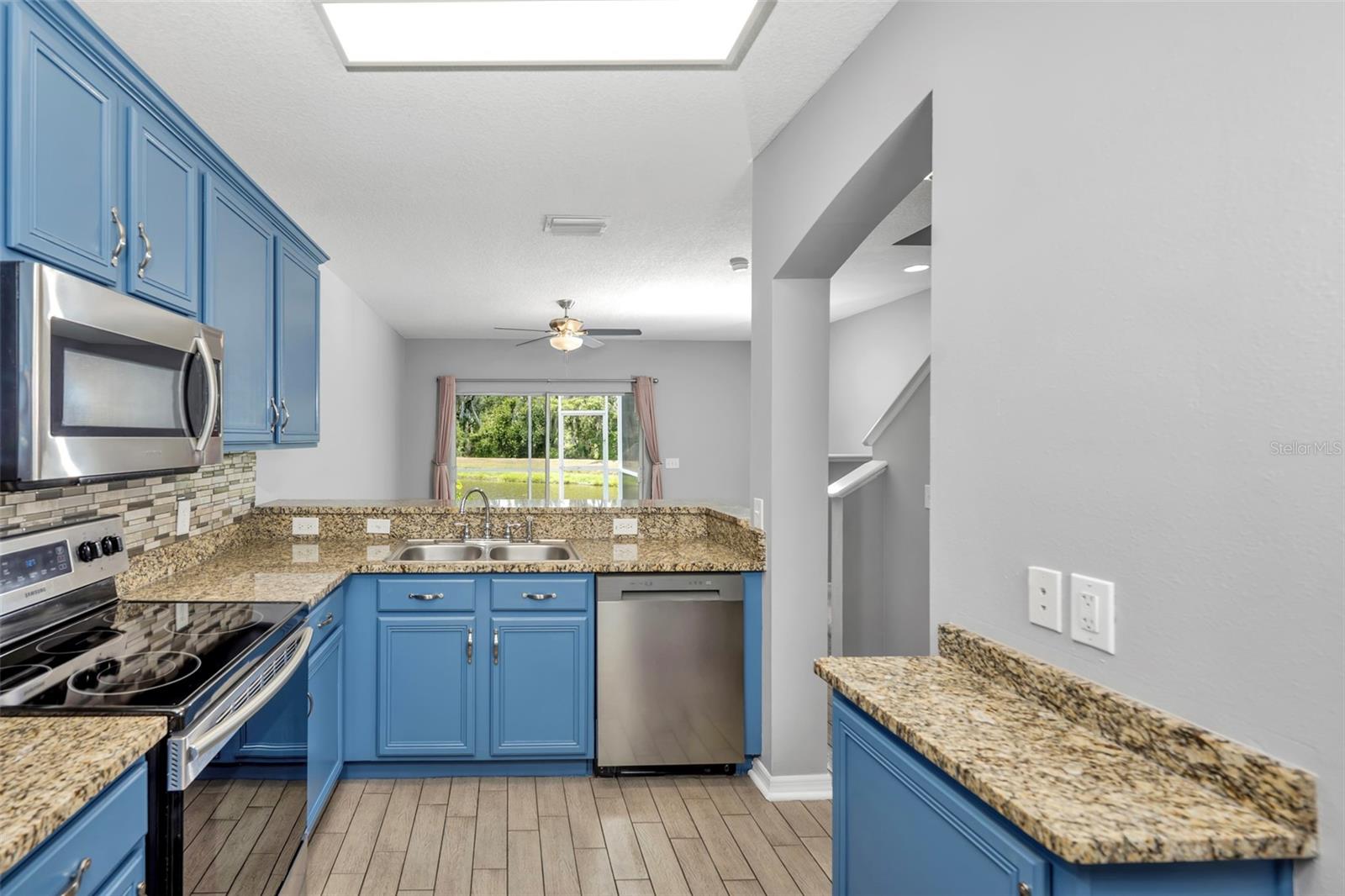 Upgraded kitchen with granite counters and stainless steel appliances