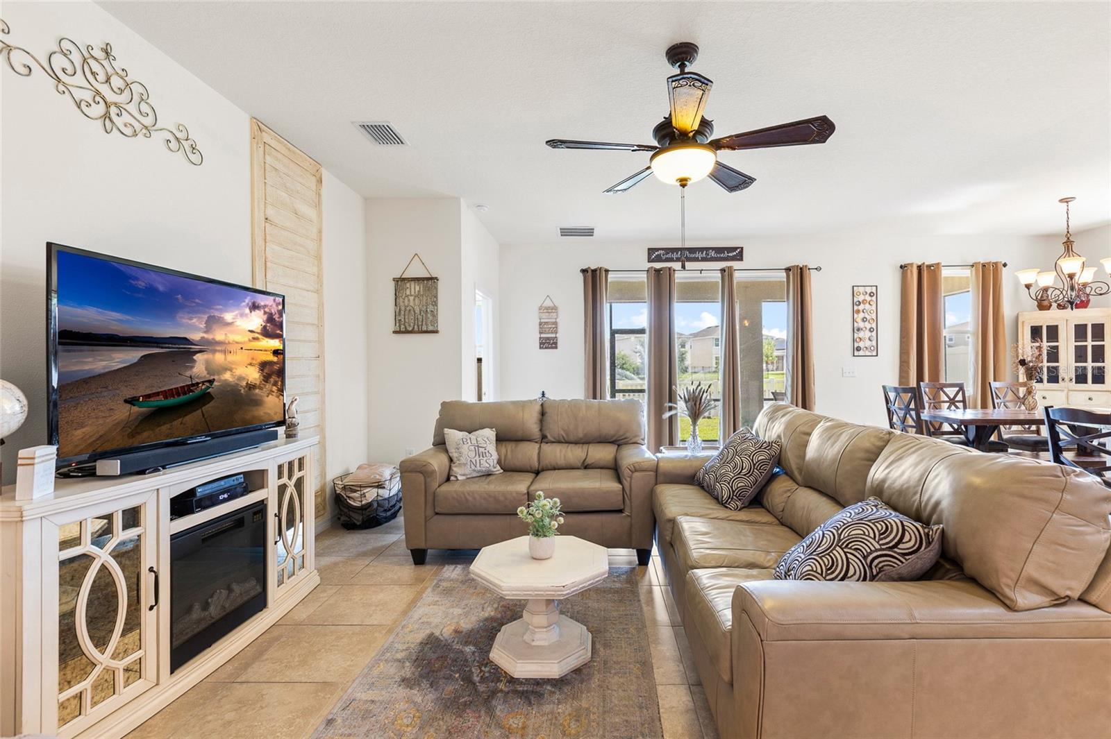 The expansive great room offers an open and inviting layout with plenty of natural light and direct views of the backyard and pond. Perfect for entertaining, relaxing, or spending time with family, this central living space flows effortlessly into the kitchen and dining area, making it ideal for today's lifestyle.