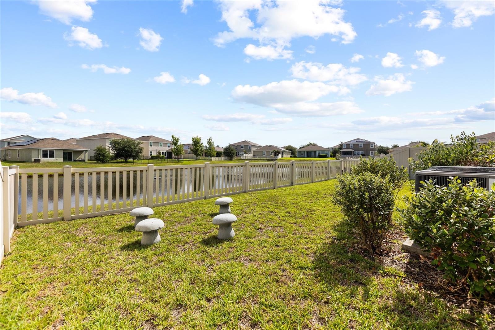 The fully fenced backyard offers privacy, security, and plenty of room for pets, play, and outdoor entertaining. Combined with the scenic pond backdrop, this outdoor space creates a peaceful retreat rarely found at this price point. The fenced yard and water view make this property especially appealing to buyers seeking both privacy and a connection to nature.