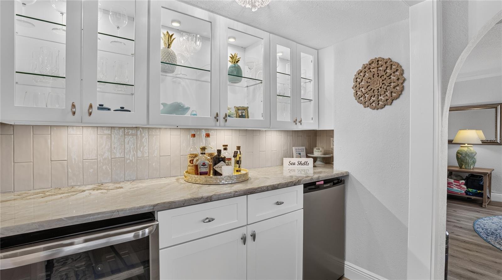 dry bar with built in ice maker and wine fridge