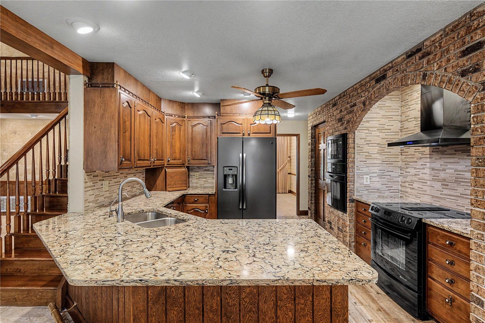 Kitchen features Breakfast bar seating and granite countertops