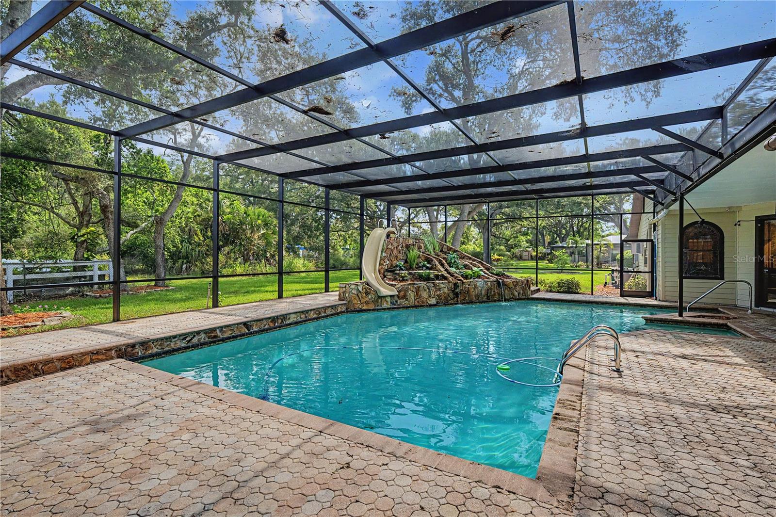 Sparkling Pool with slide, waterfall and screen.