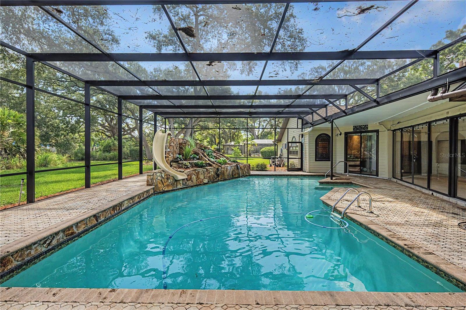 Sparkling Pool with slide, waterfall and screen.