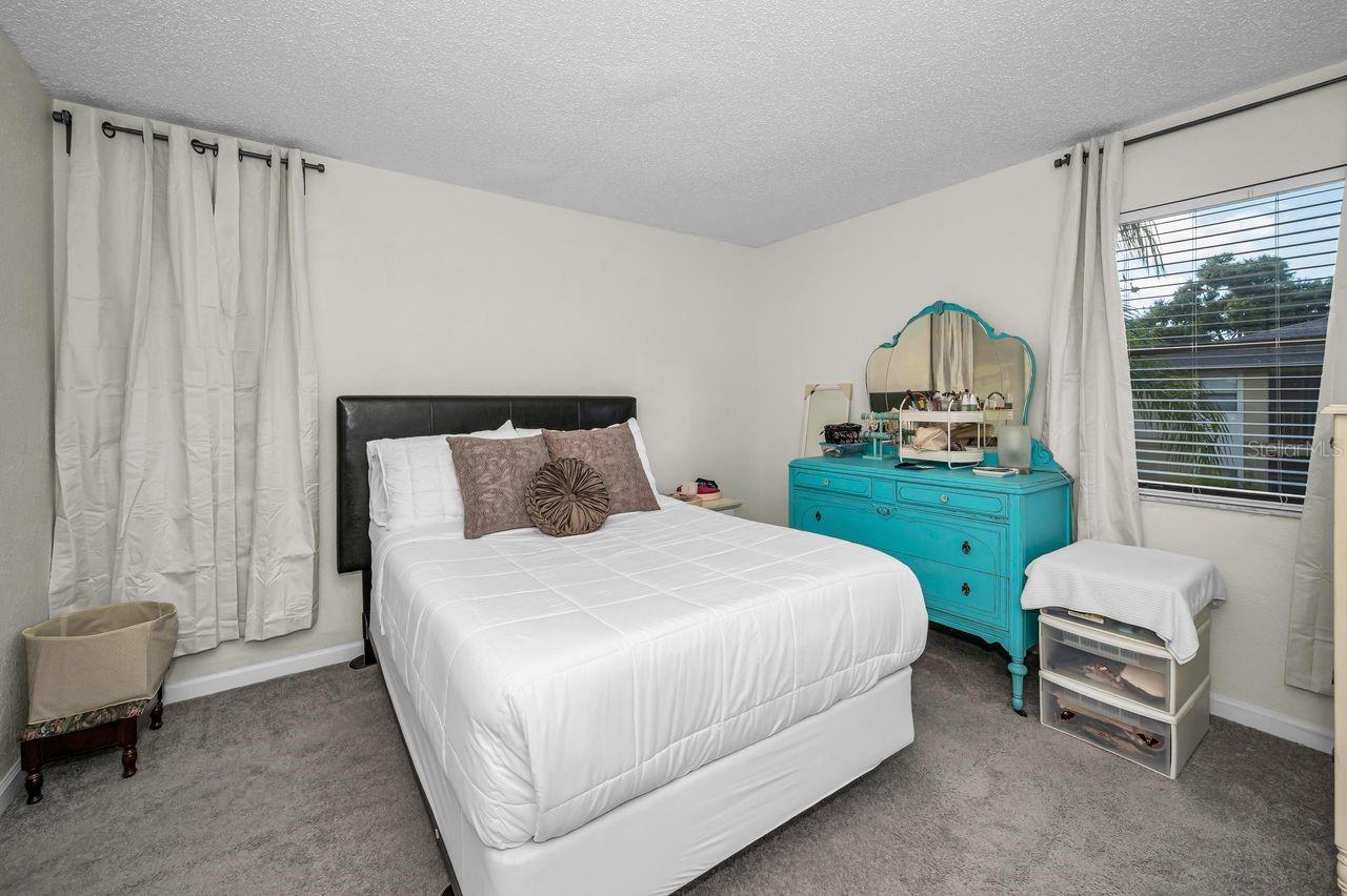 Primary bedroom offers windows to view side and rear of property.