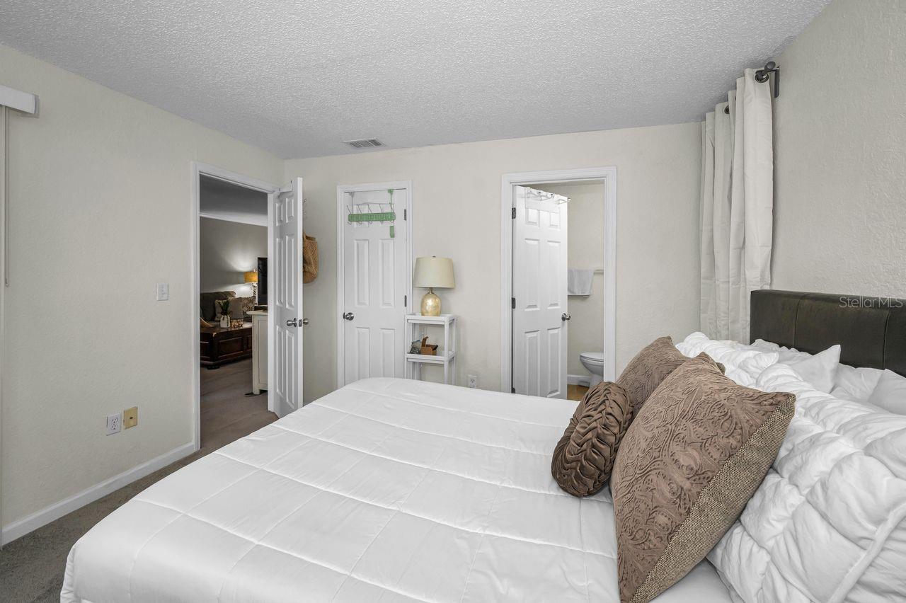 Doorway to living area, walk-in closet, and primary bath