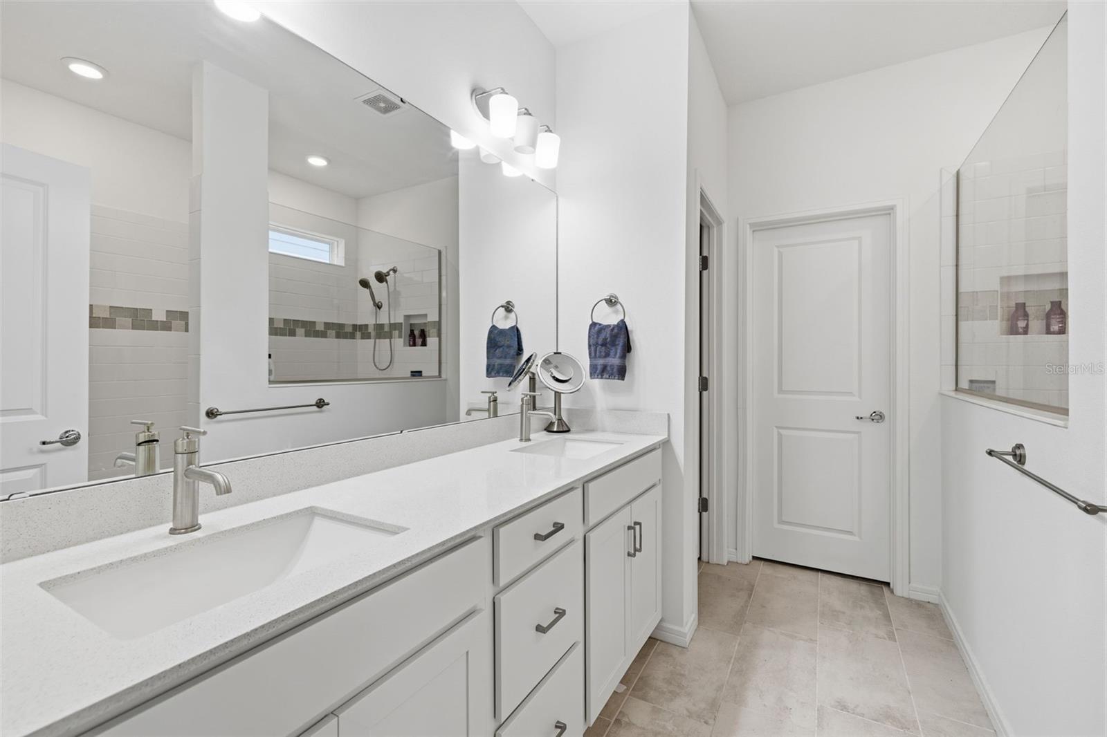 Primary bathroom with double sink Quartz vanity, walk-shower, water closet