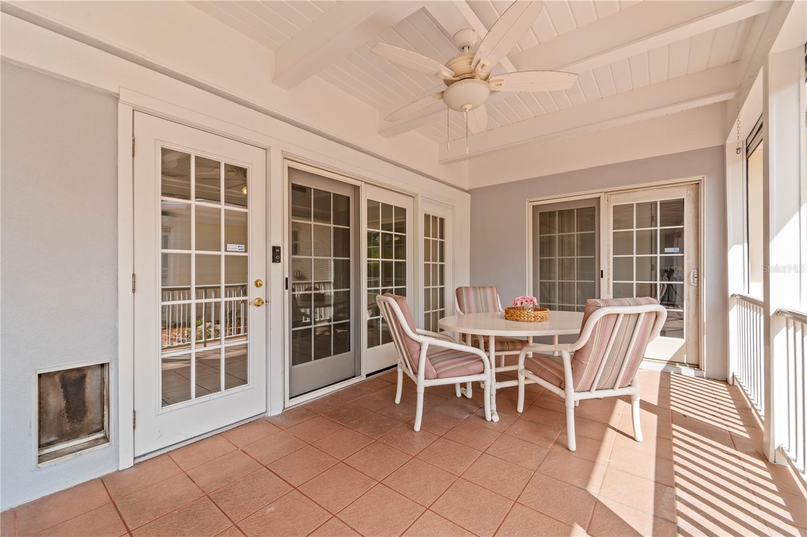 Great sized back porch with hurricane shutters on the outside of it