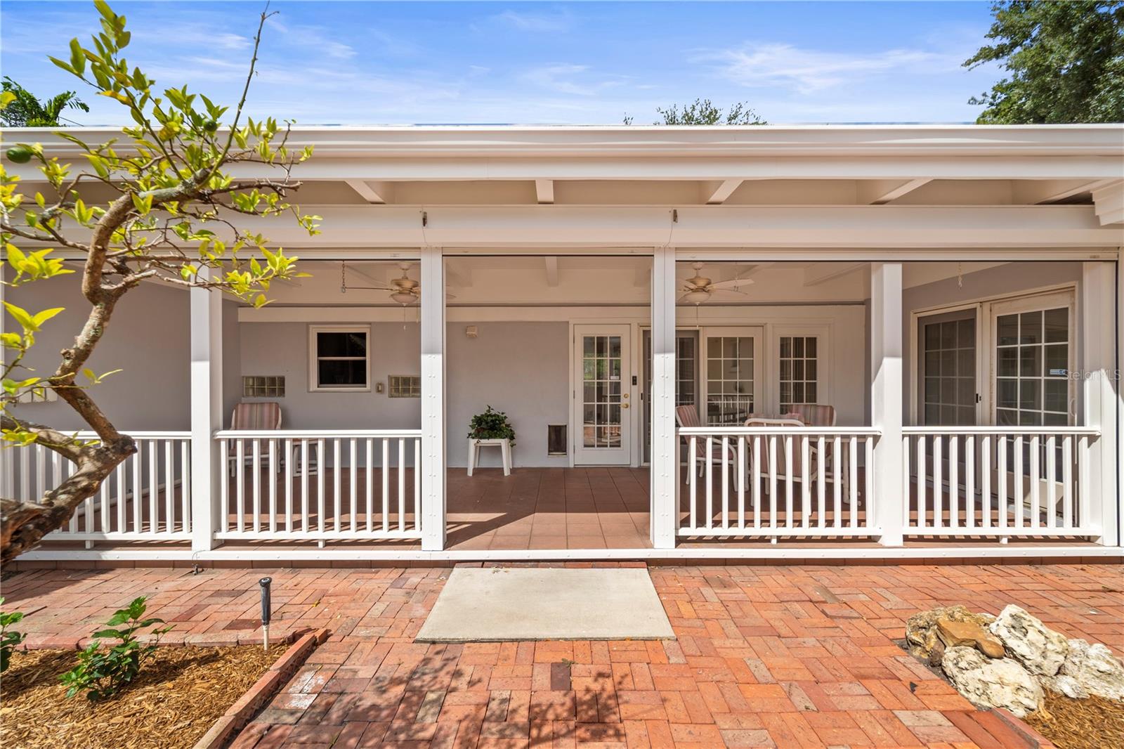 Hurricane shutters roll down along porch
