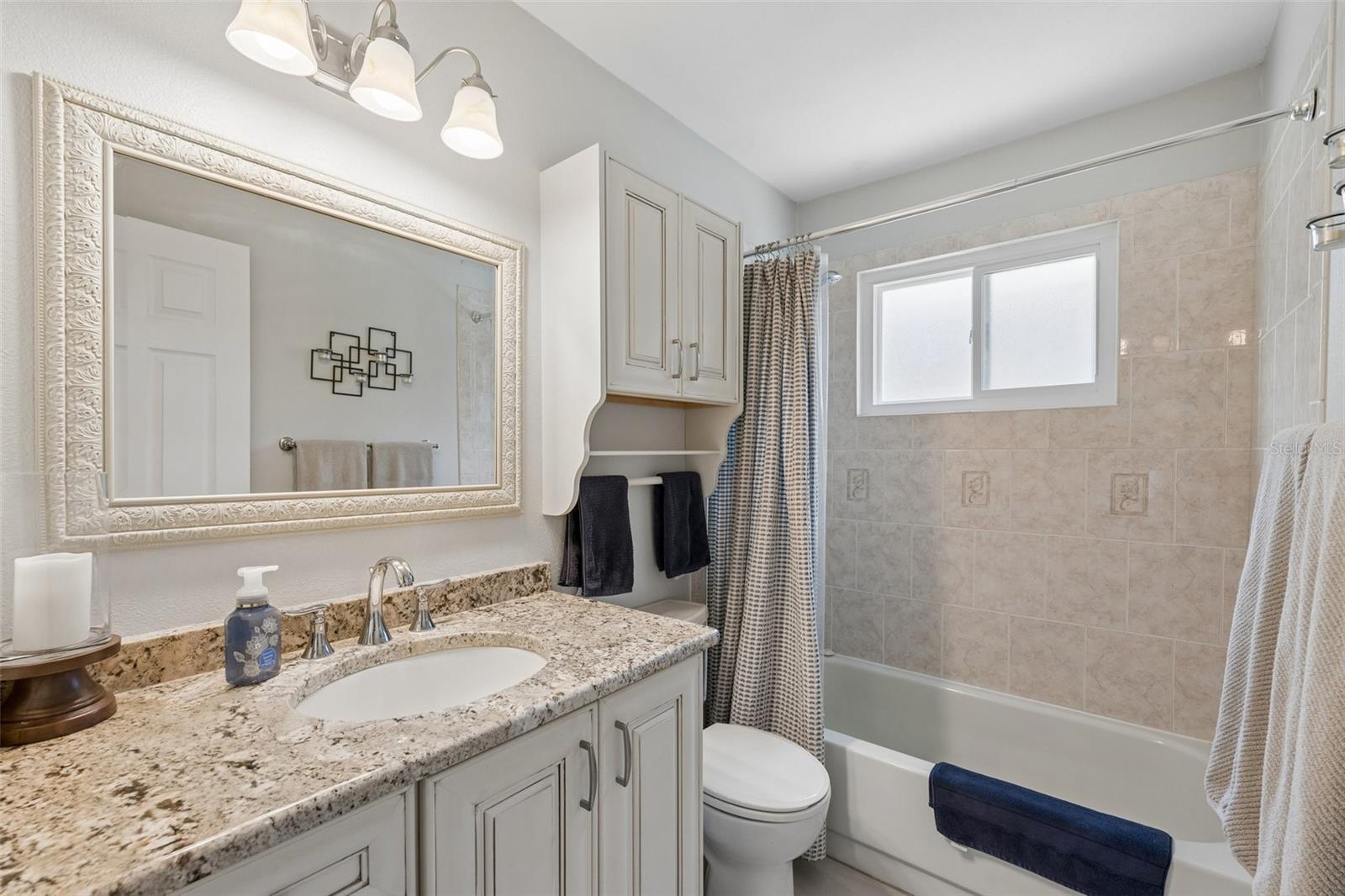 Beautifully appointed second bathroom with tub/shower combination, stylish vanity and ample counterspace.