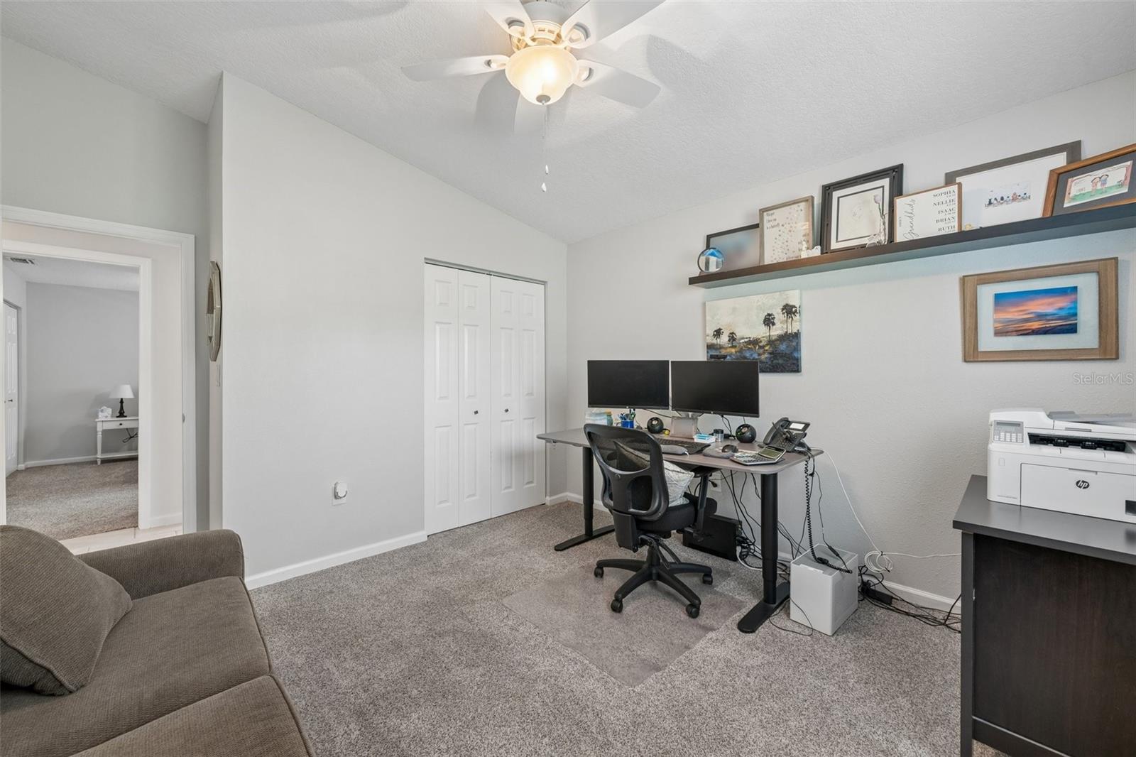 Third bedroom with vaulted ceiling and neutral tone carpet