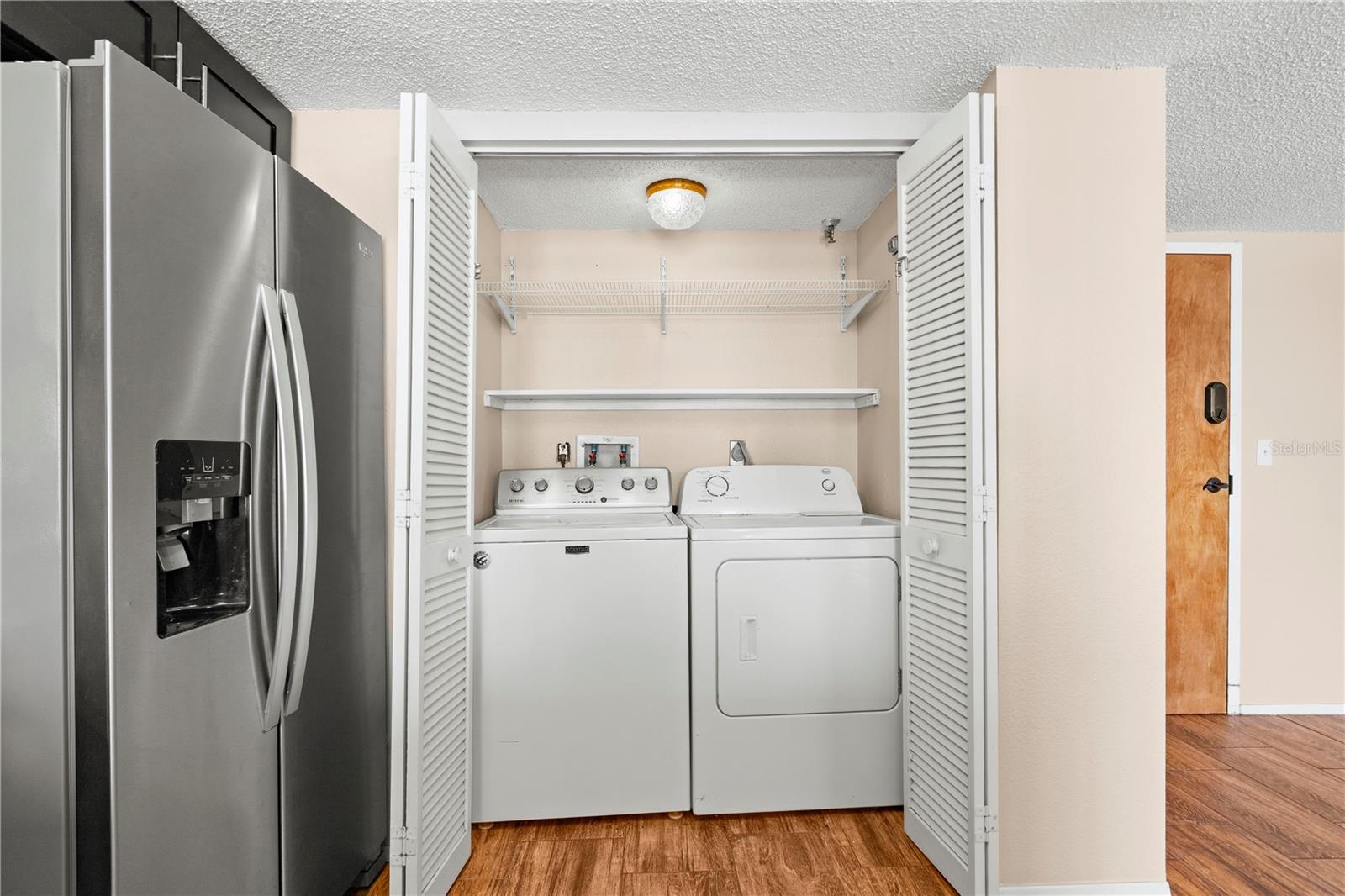 Private laundry closet in the kitchen.