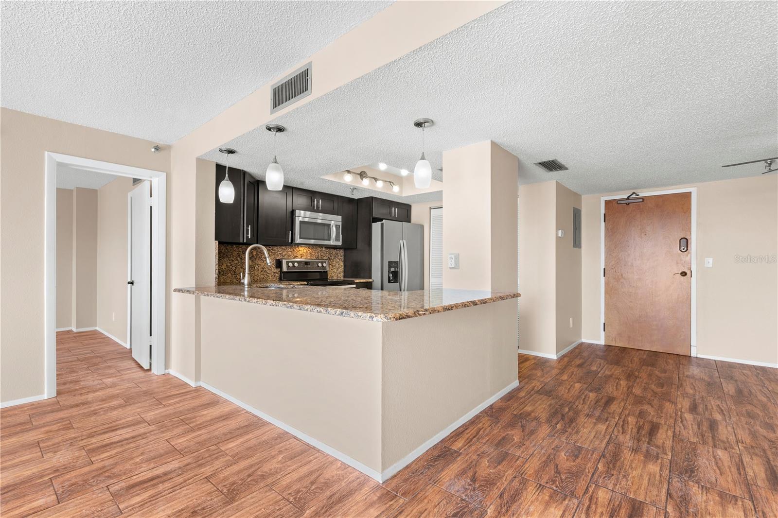 Now this is "Island Living"... granite counters, with space for added seating all around.