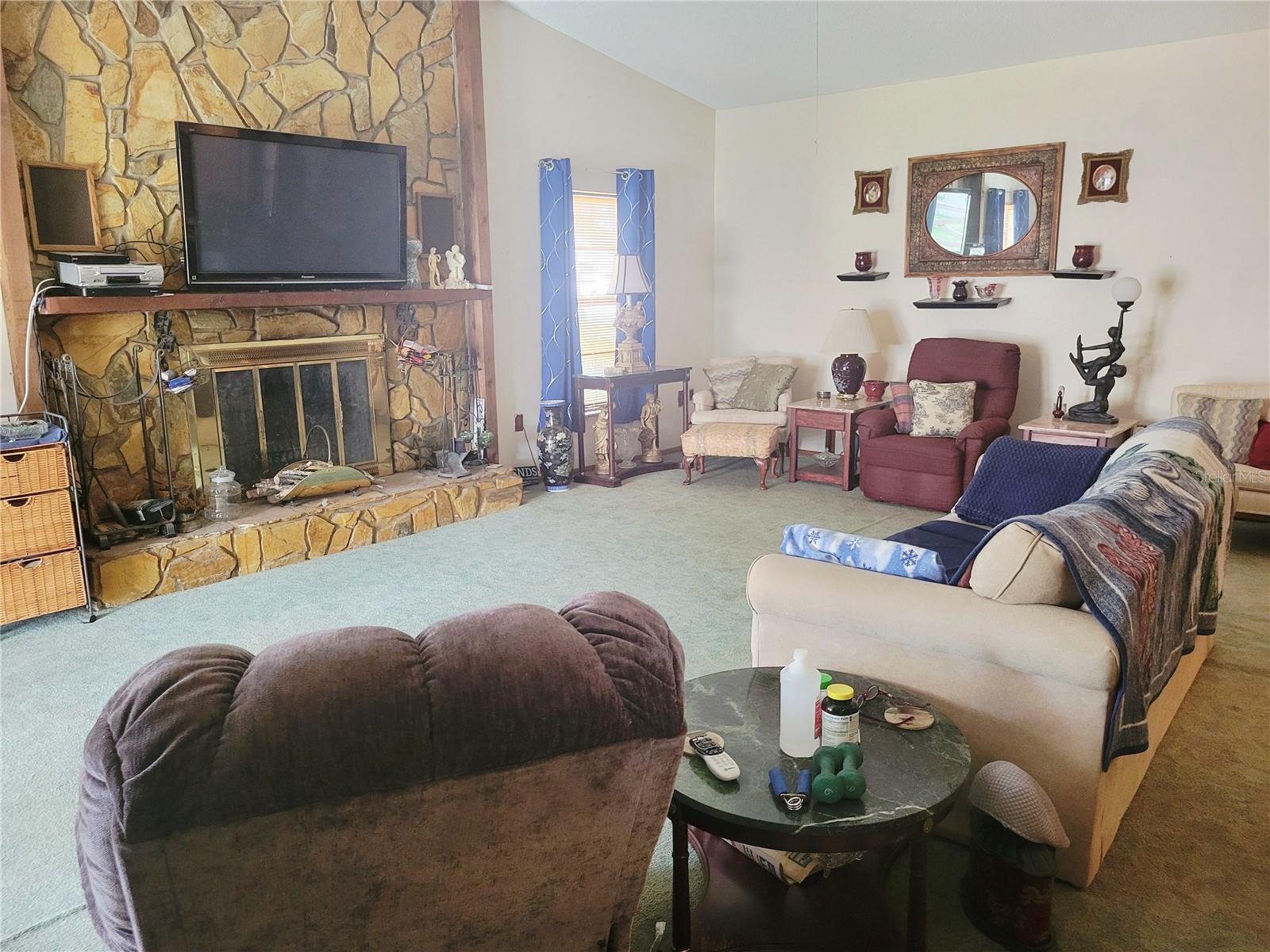 Family room with stone woodburning fireplace