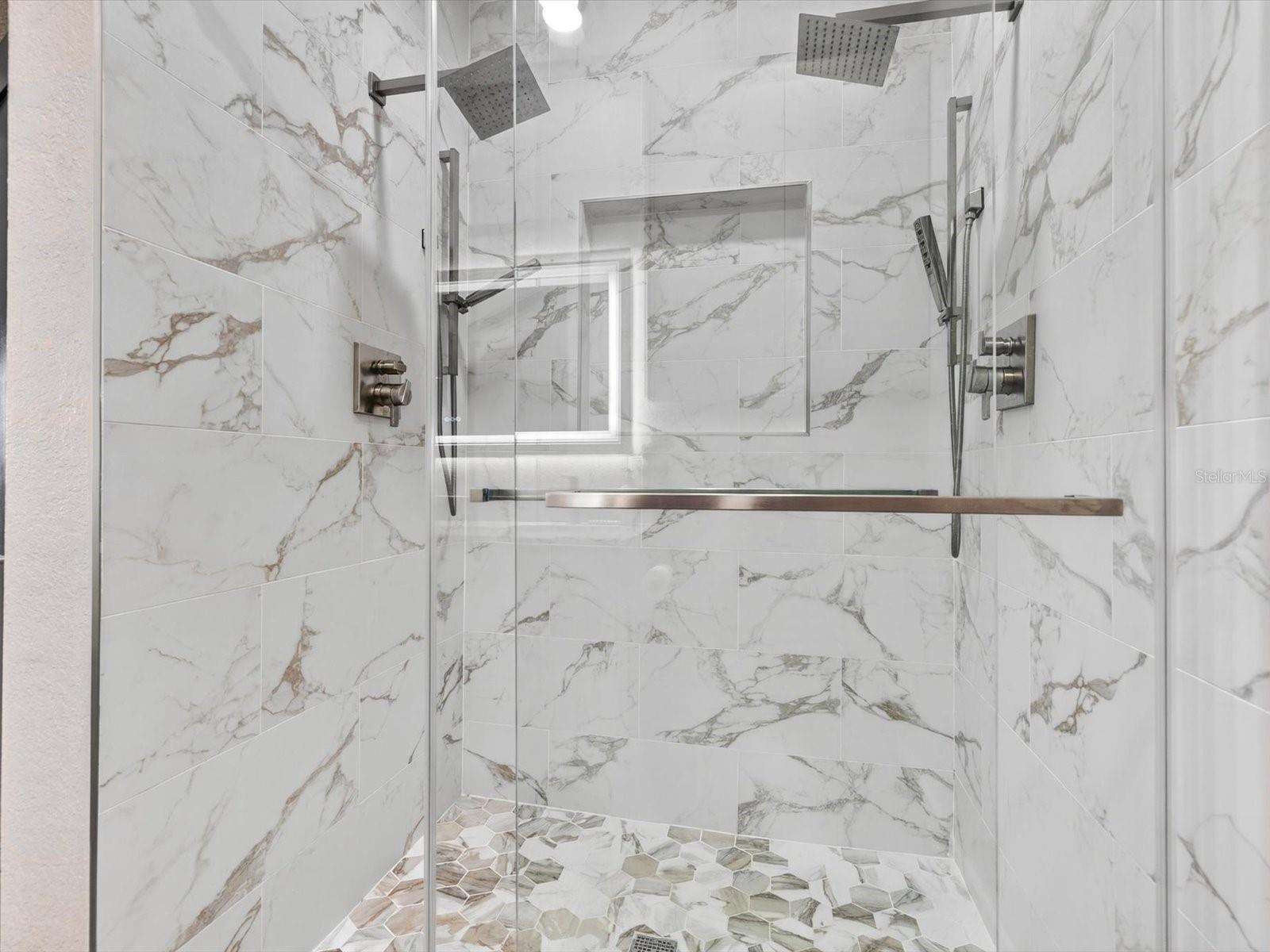 Renovated bathroom with three shower heads