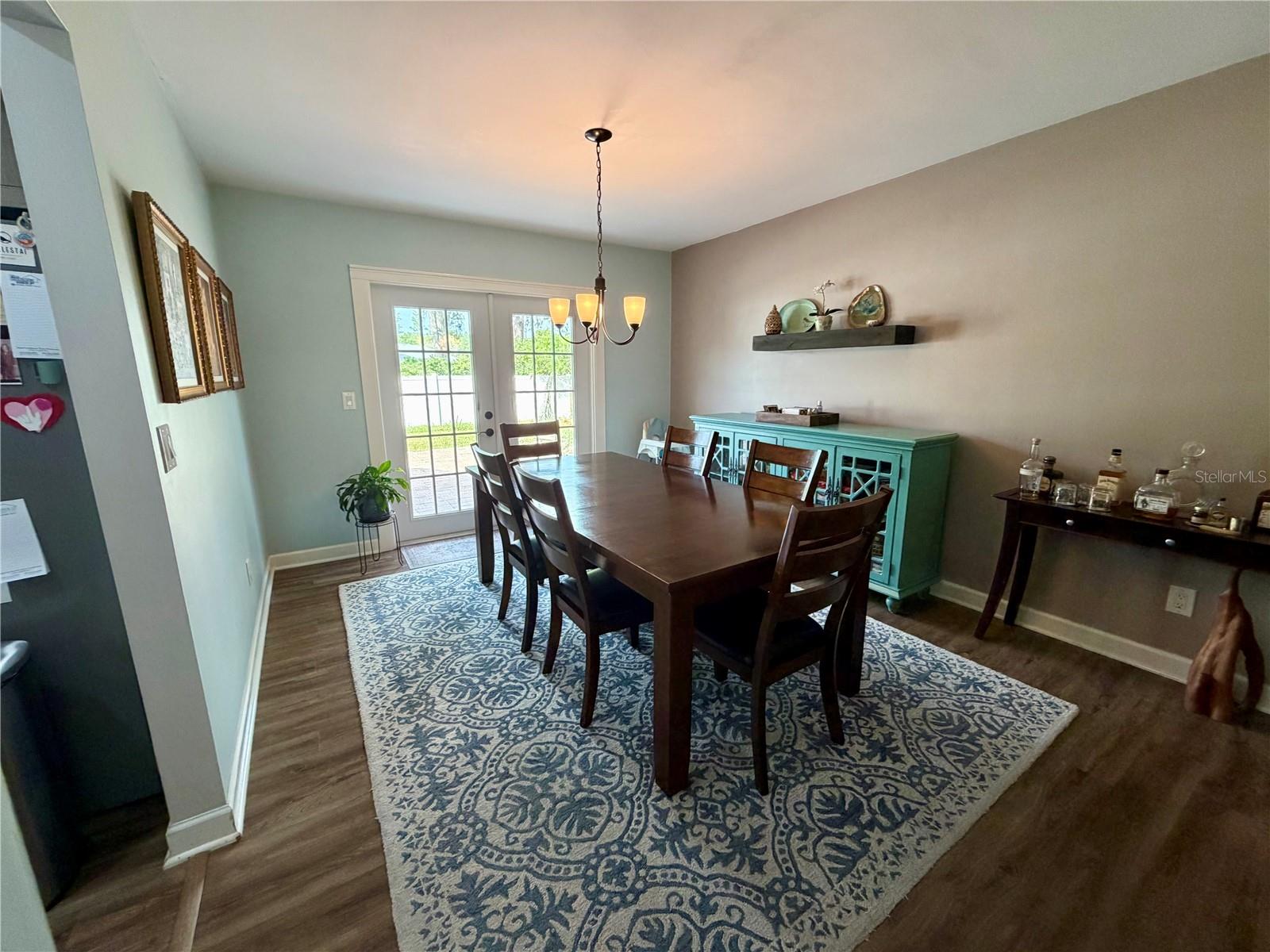Large dining room accommodates plenty of furniture and French Doors lead to the paver patio
