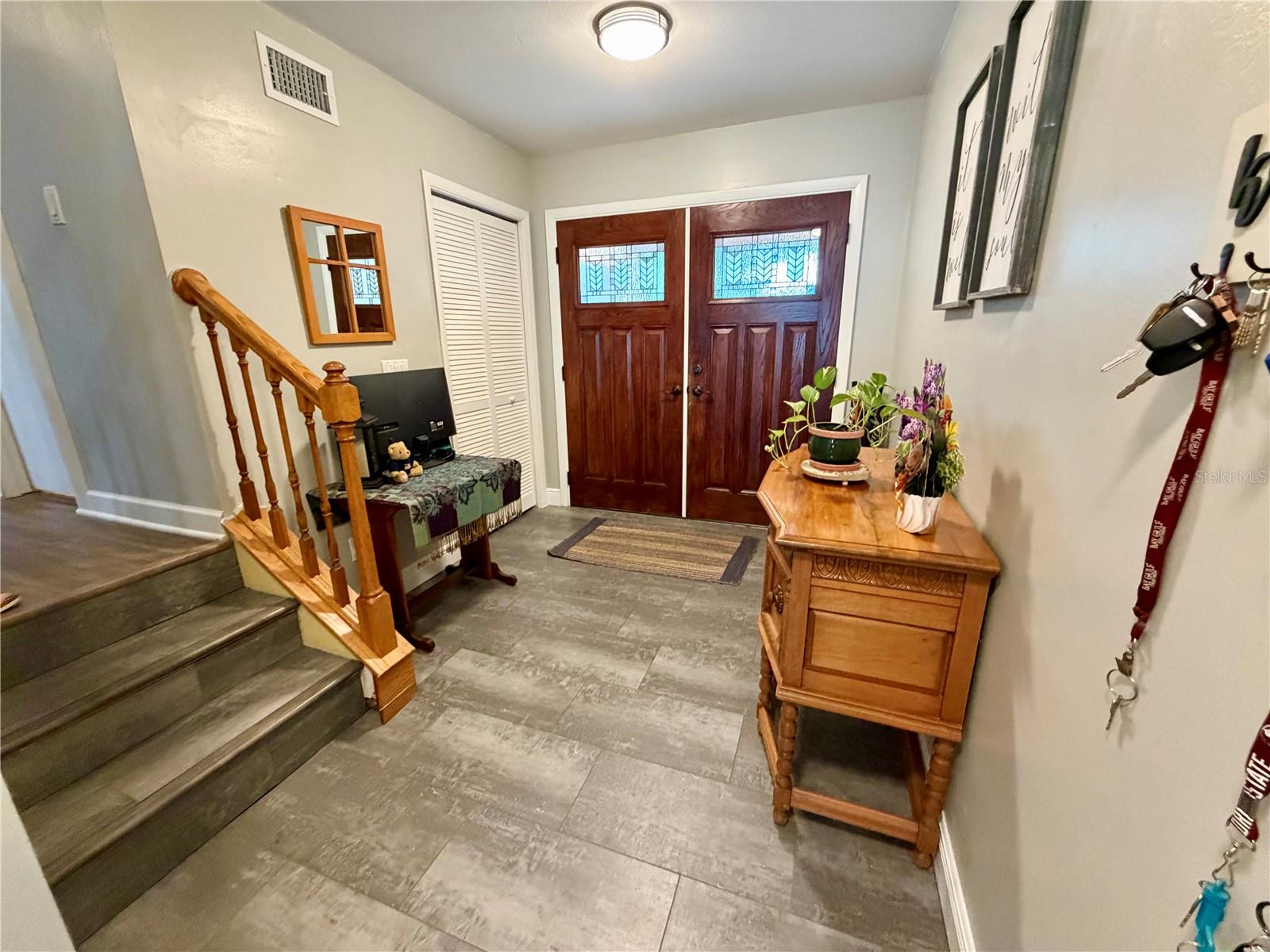 Welcoming front door and foyer with stairs to main living level