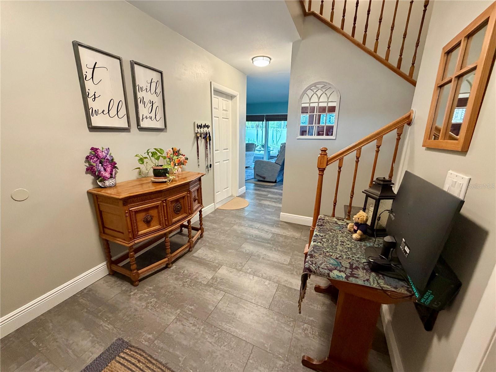 Stairs from the foyer lead to the living room, dining room and kitchen on main living level