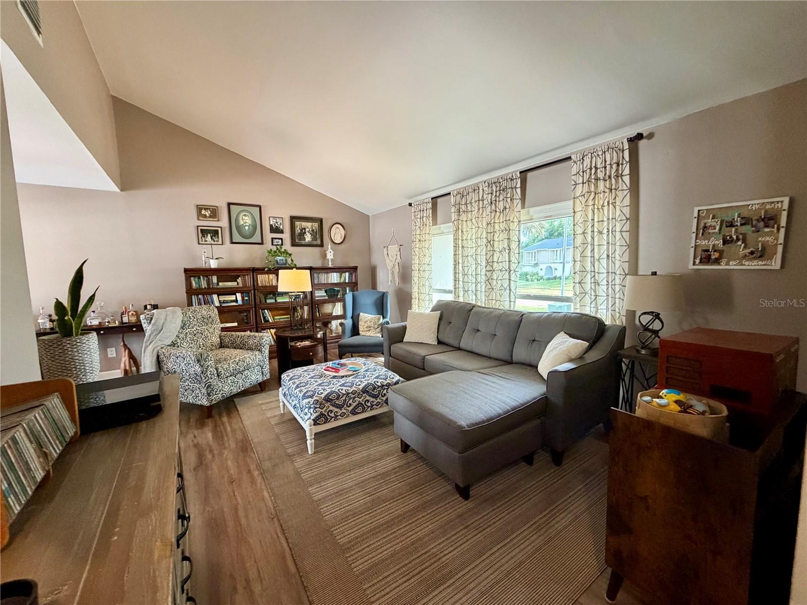 Formal living room with vaulted ceilings adjacent to the dining room