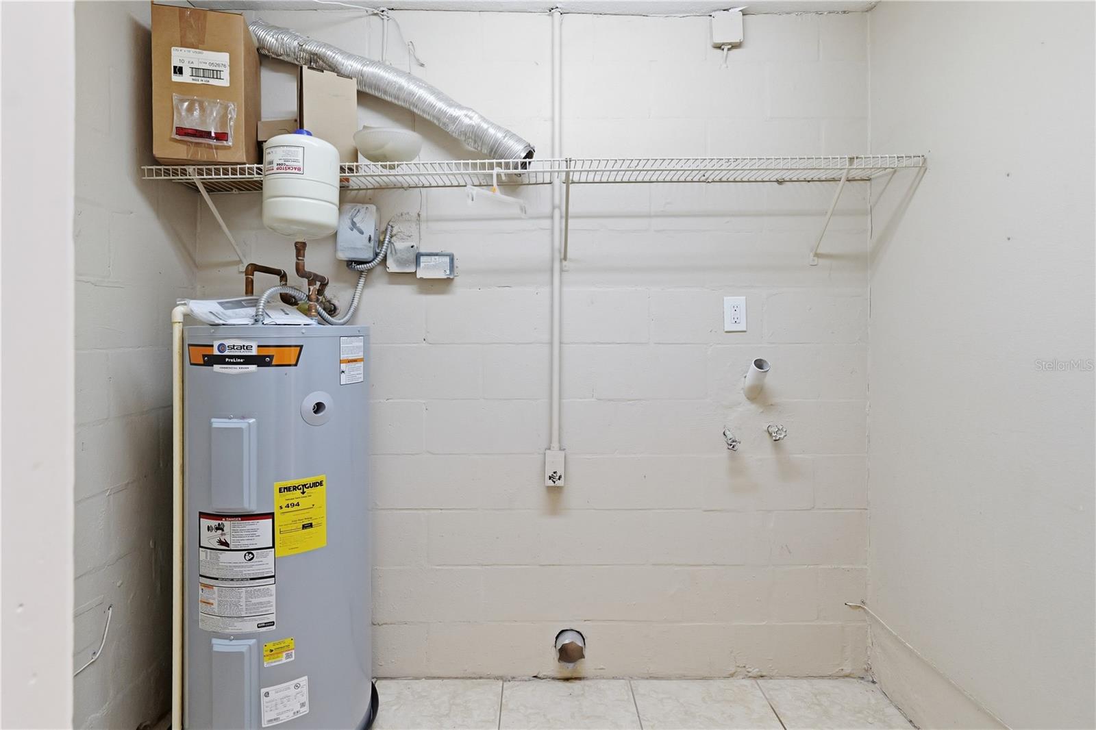 Newer water heater located in laundry room